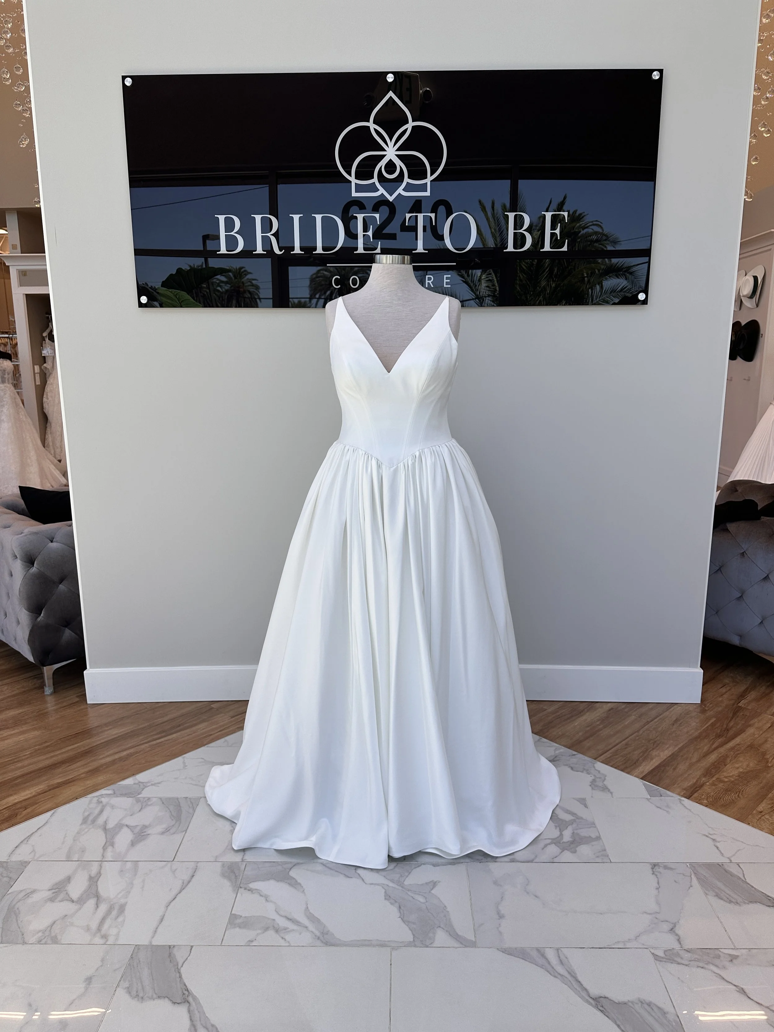 Legacy Maya satin A-line wedding dress with a V neckline at Bride To Be Couture Sacramento.