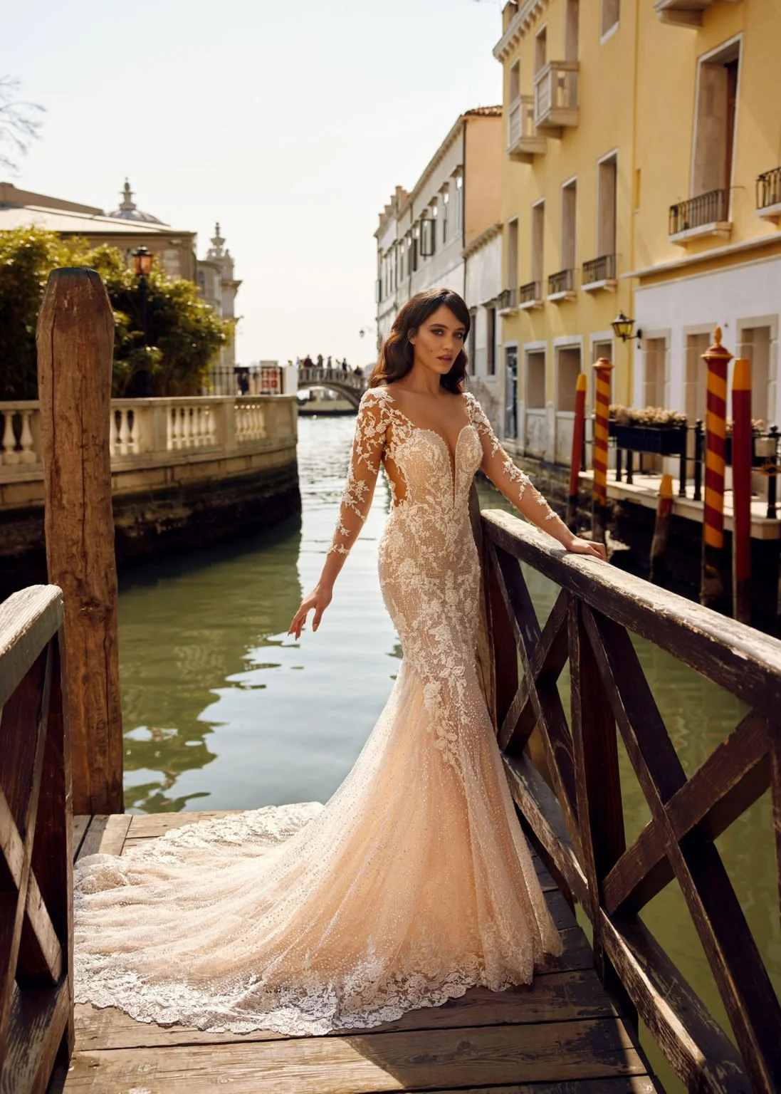 Madam Burcu Style 3054 mermaid wedding gown with plunging V-neck, sheer long lace sleeves, and all-over lace embroidery on champagne blush base