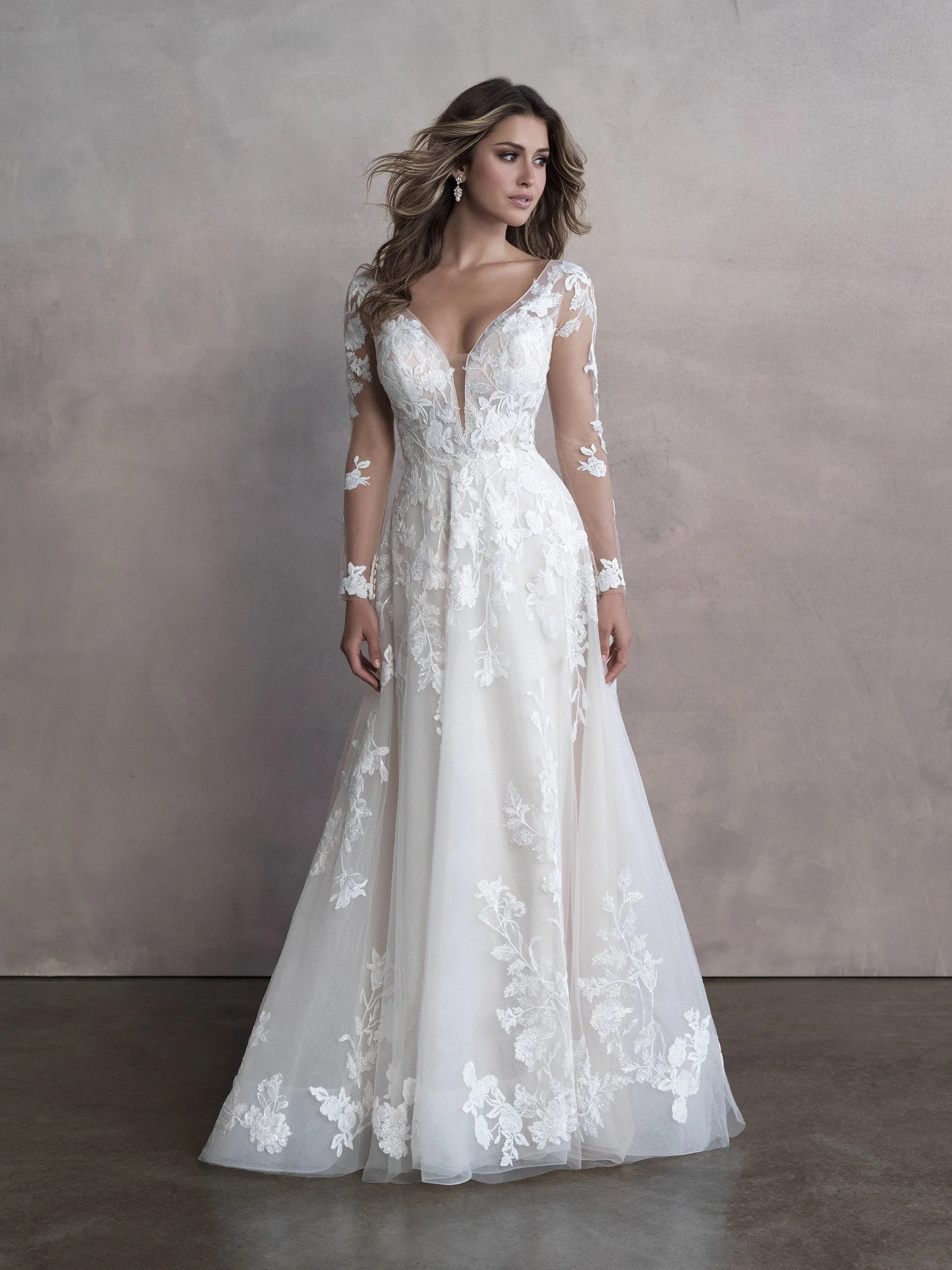 Long Sleeve Lace Wedding Dress With Plunging Neckline and Flowing Aline Skirt