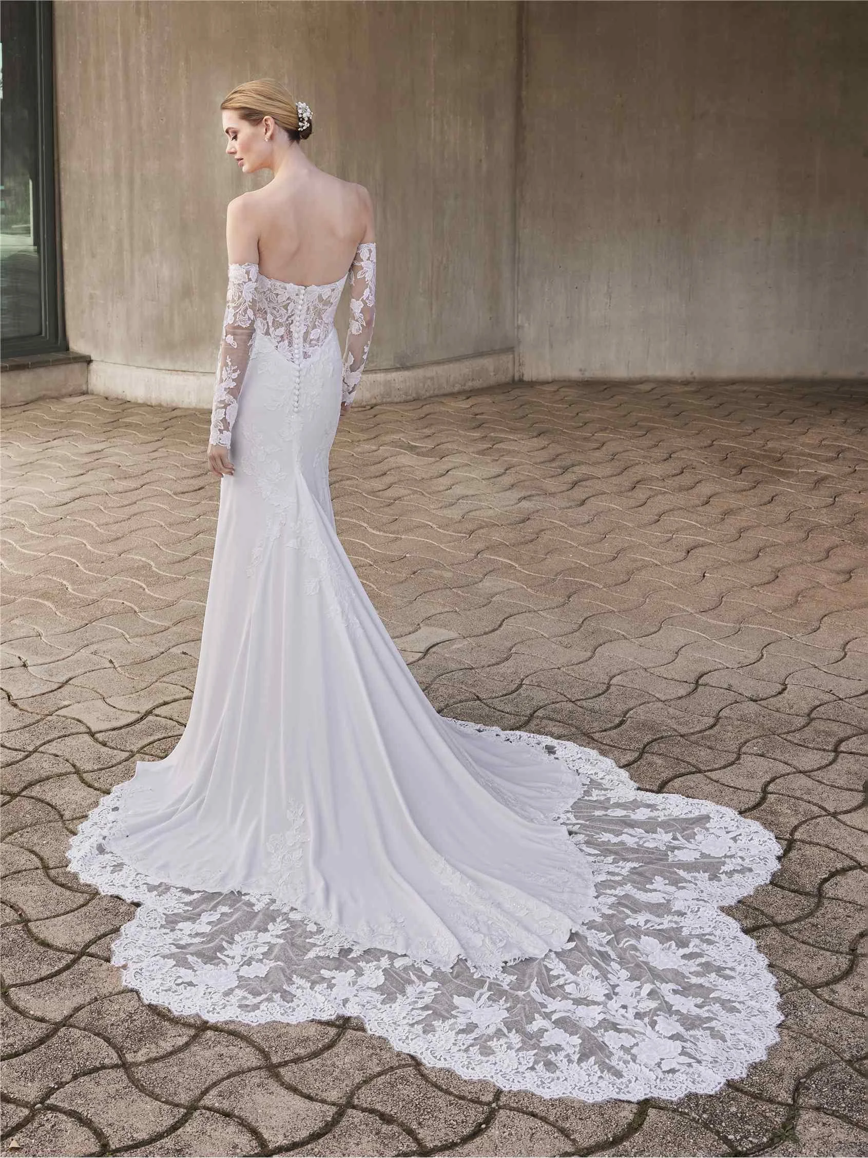 Pronovias Anok mermaid wedding dress in crepe with a sweetheart neckline, intricate lace bodice, and Basque waist fading into a clean crepe skirt.
