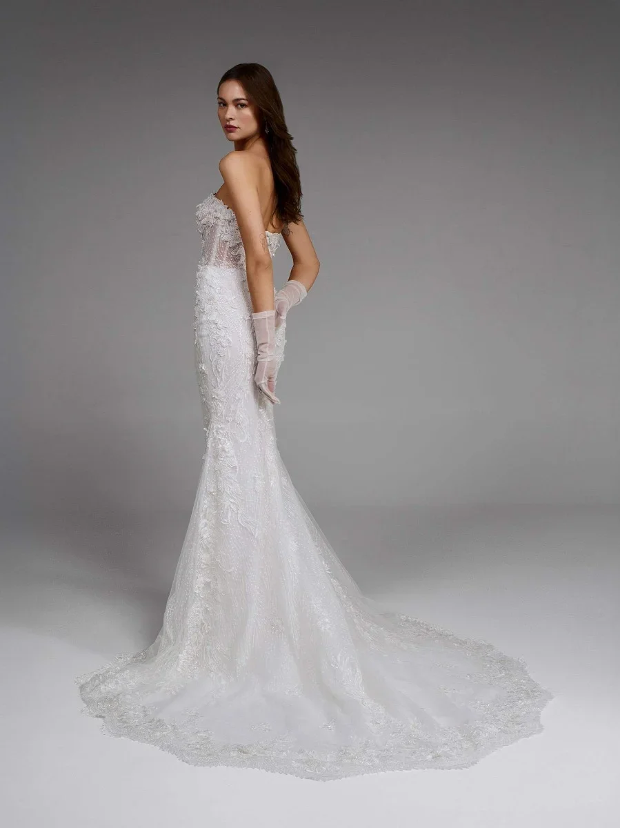 Pronovias Aethra mermaid wedding dress with a plunging sweetheart neckline, 3D floral lace appliqués, embroidered thread detailing, and a sculpted open back.