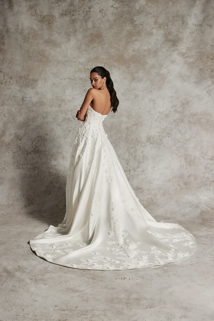 Justin Alexander Signature Amani 99291 satin A-line wedding gown with pointed scoop neckline, 3D floral appliques, and chapel train.