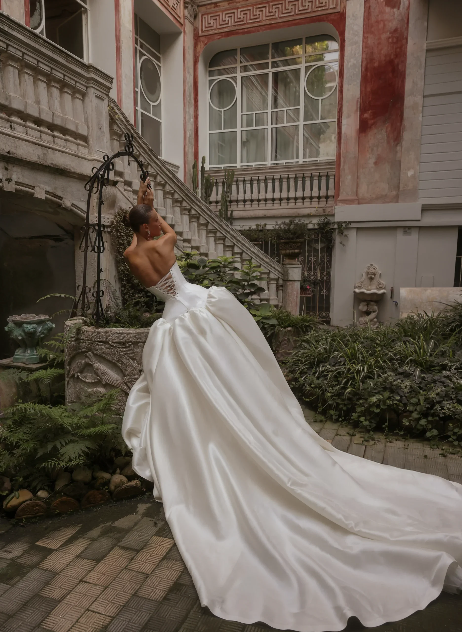Bride wearing the Eden Aharon Silvia champagne Italian Mikado strapless wedding dress with dramatic puffed skirt