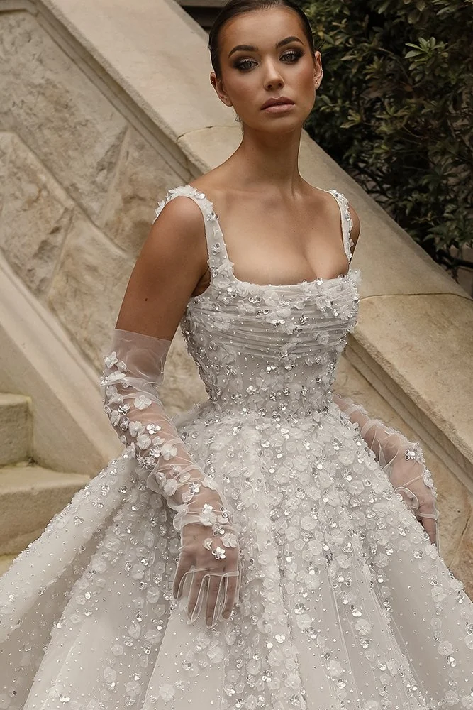 Jaz by Steven Khalil sparkling ball gown wedding dress with square neckline, embellished straps, floral appliqués, and dramatic full skirt at Bride To Be Couture Sacramento