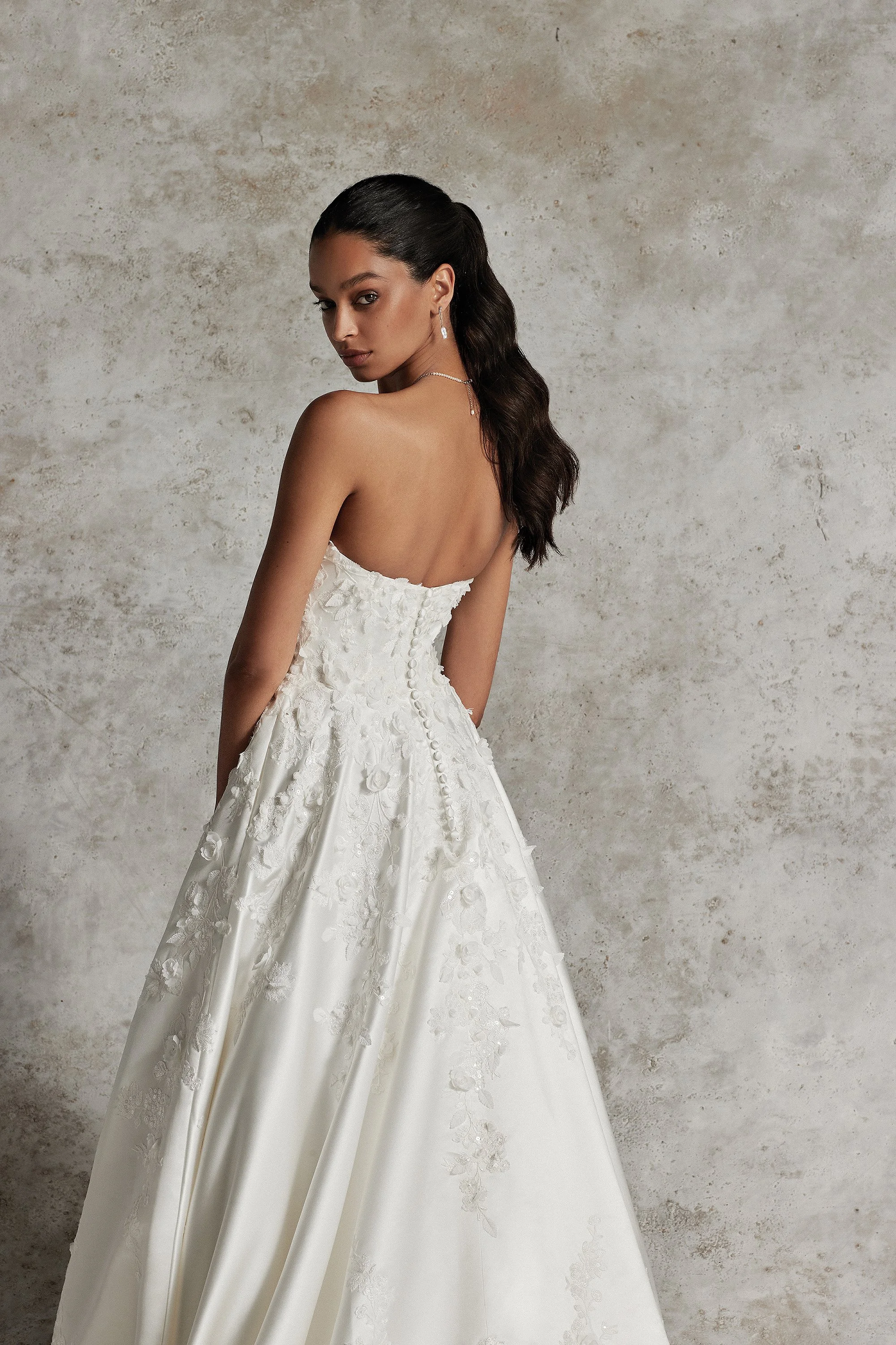 Justin Alexander Signature Amani 99291 satin A-line wedding gown with pointed scoop neckline, 3D floral appliques, and chapel train.
