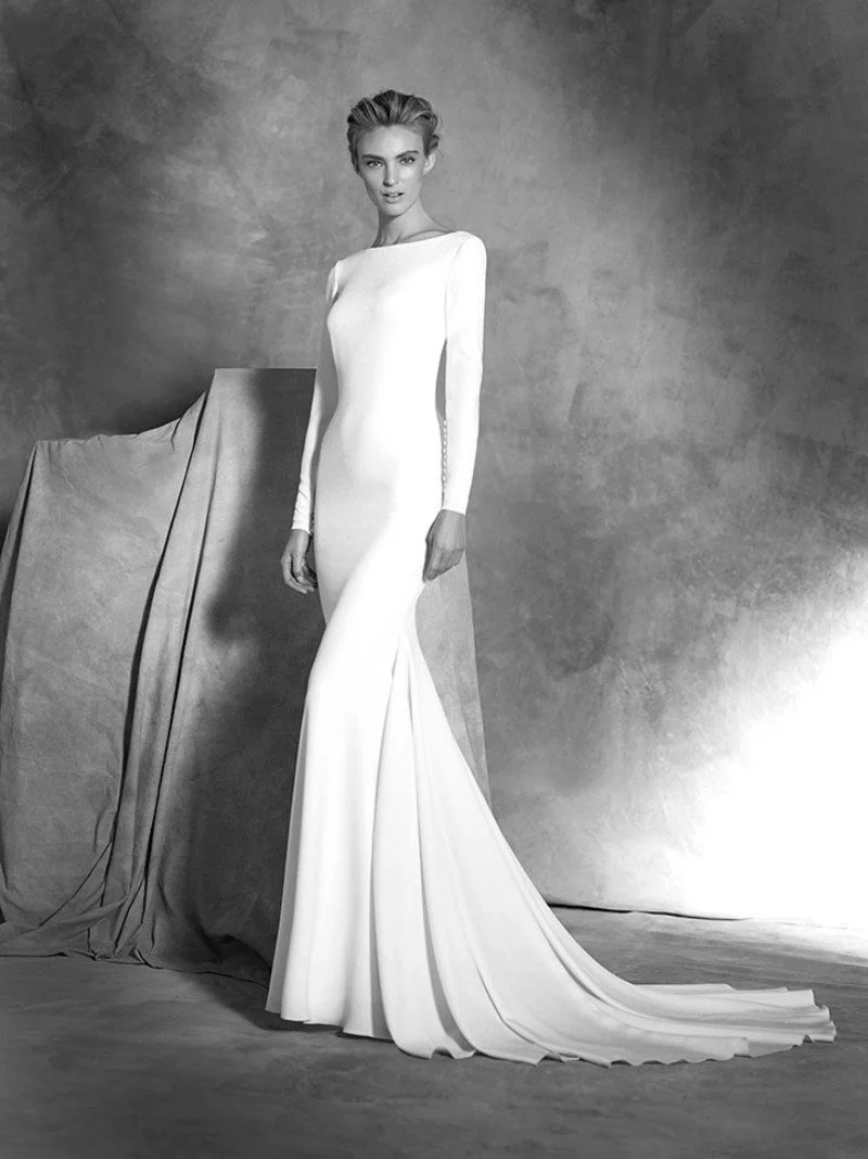 Pronovias Ivania crepe mermaid wedding dress with bateau neckline long sleeves and fitted silhouette at Bride To Be Couture Sacramento Front.jpg
