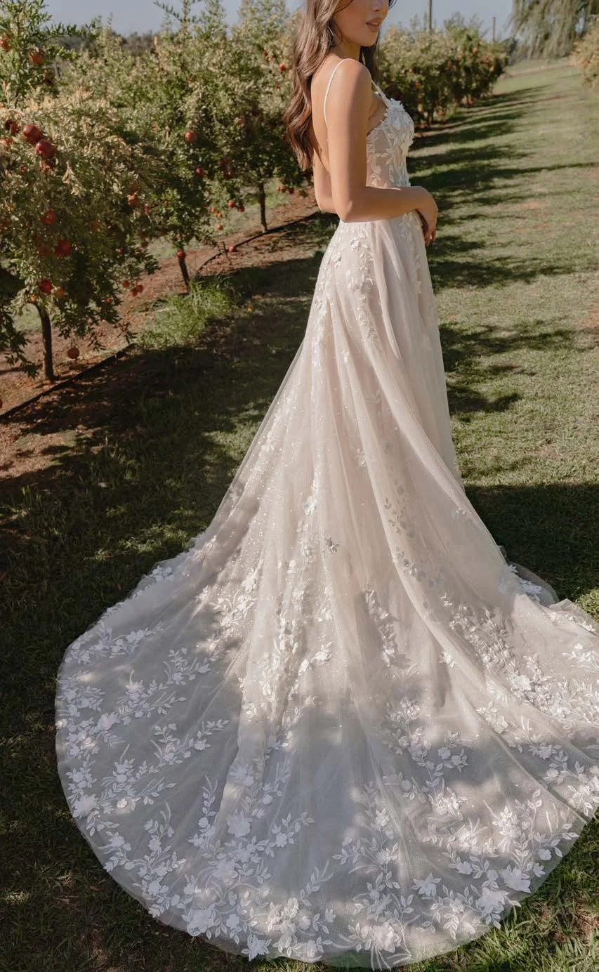 Madi Lane Sarie A-line wedding gown with a sweetheart illusion bodice, beaded tulle straps, botanical lace with sequins and 3D motifs, and a cathedral-length train.