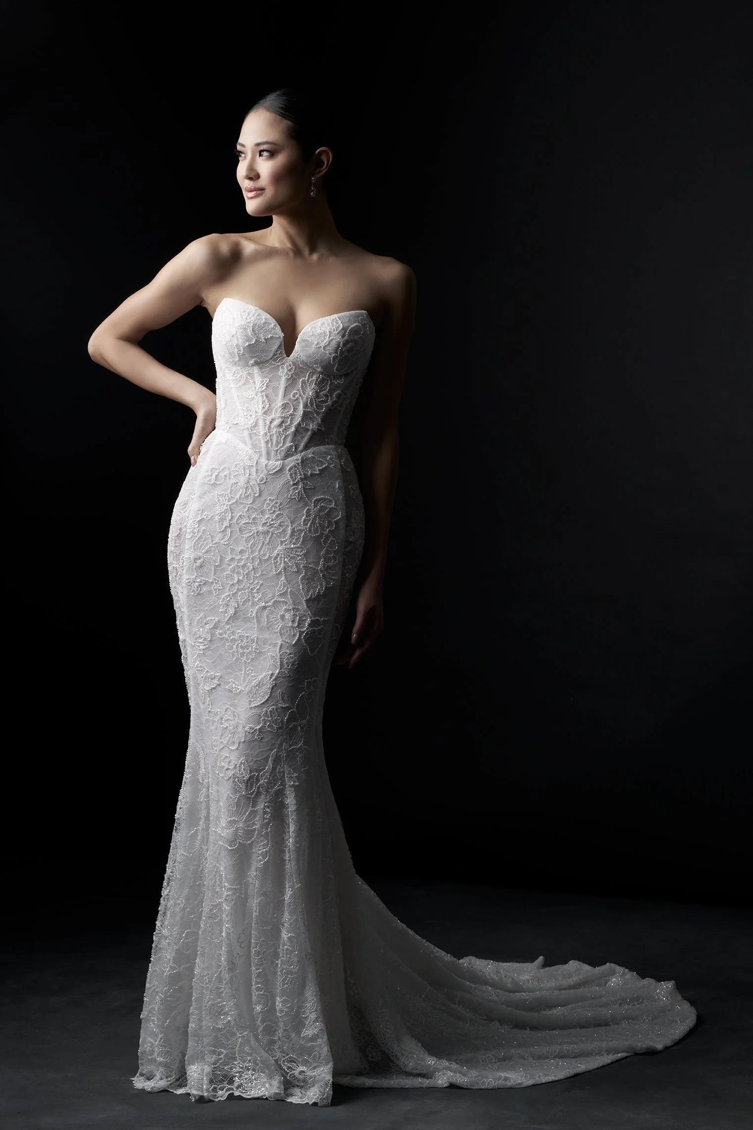 Allure Couture C782NC strapless sweetheart sheath wedding gown with a soft basque waistline, beaded sequin lace appliques, and sheer side panels from bodice to hem.