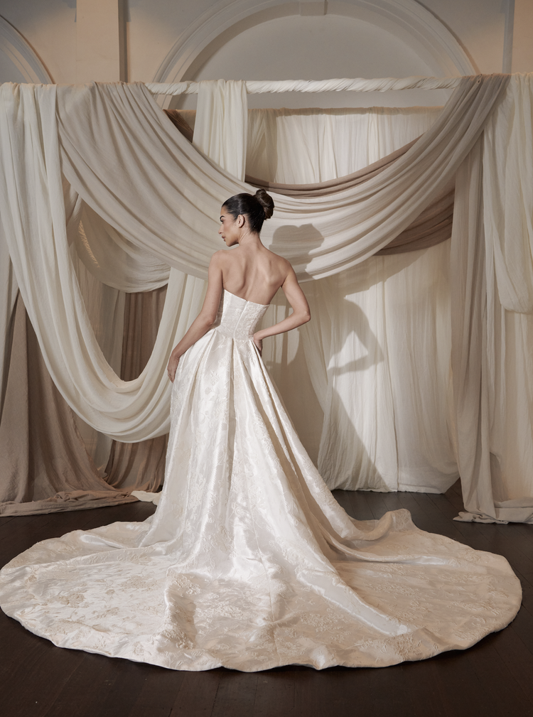 LUXURIOUS STRAPLESS A-LINE WEDDING DRESS WITH FLORAL JACQUARD FABRIC AND A ROMANTIC COUTURE SILHOUETTE.
