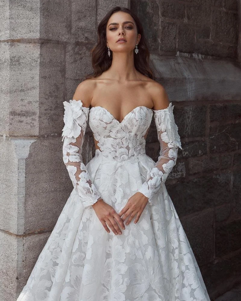 Calla Blanche Callista 124126 classic A-line lace wedding dress with strapless sweetheart neckline, intricate floral 3D lace, pockets, and detachable long sleeves.