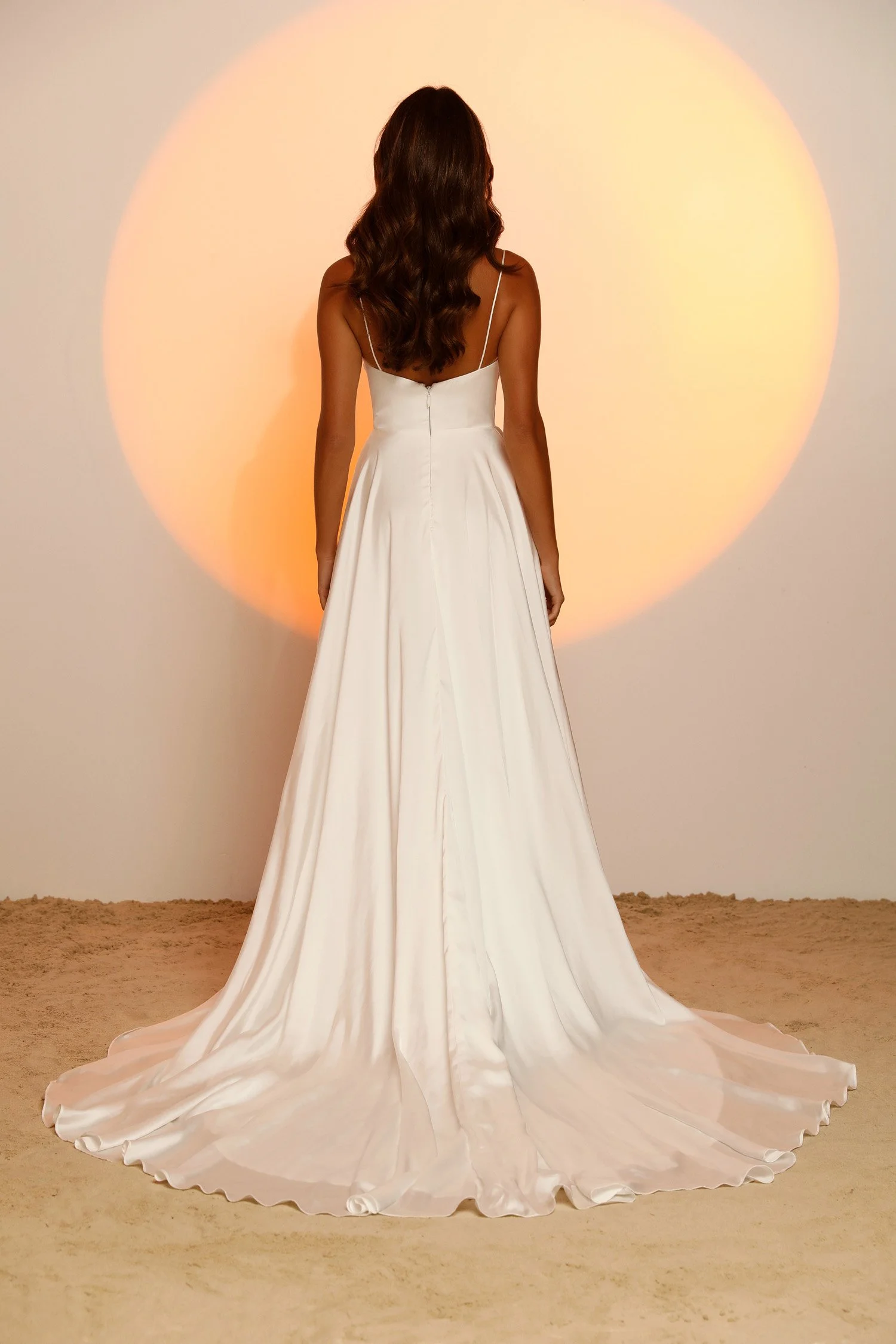 Madi Lane Jesse minimalist A-line wedding dress in soft luxe satin chiffon with a cowl neckline, thin rouleau straps, soft V-back, and high leg split.