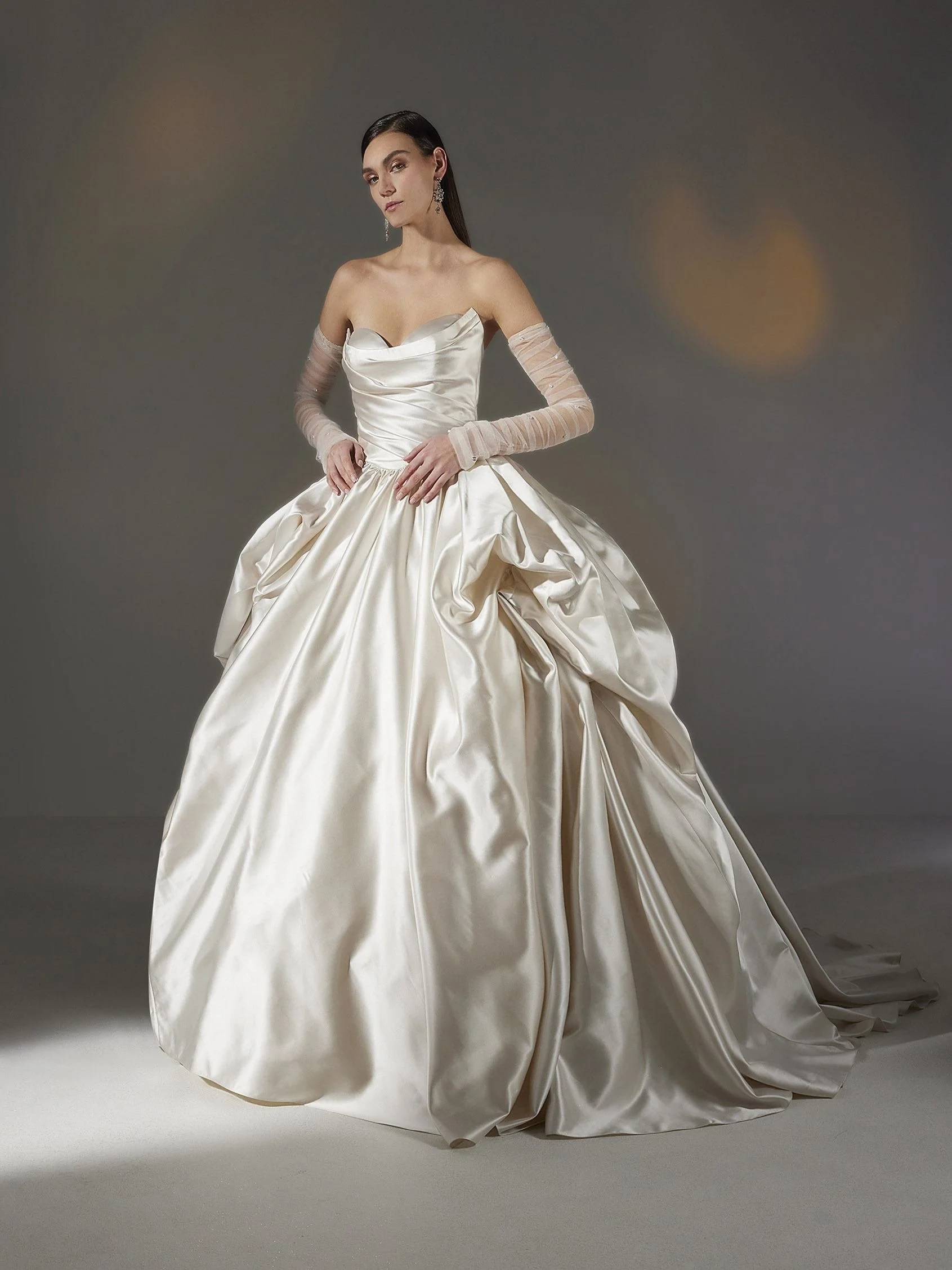 Pronovias Devonne satin princess wedding dress with a sleeveless sweetheart bodice, soft draping, and full sweeping skirt.