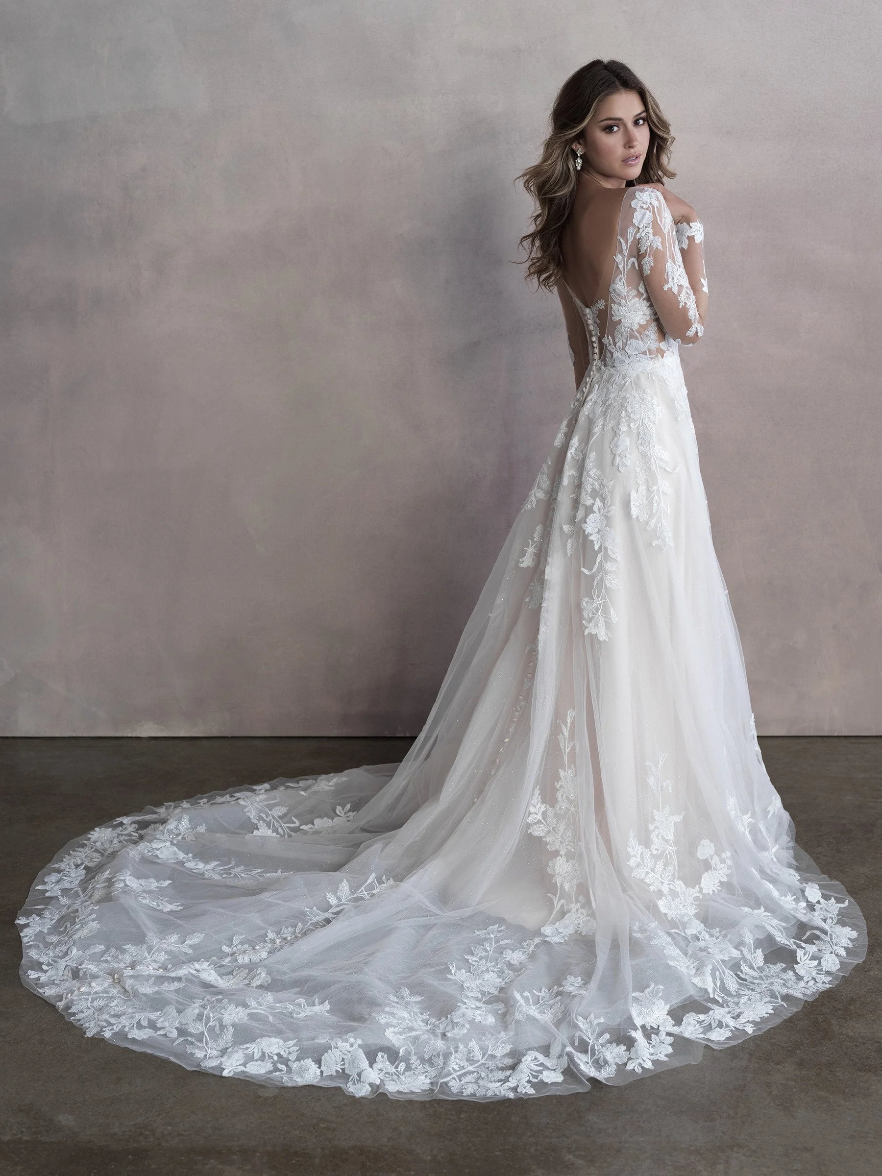 Long Sleeve Lace Wedding Dress With Plunging Neckline and Flowing Aline Skirt