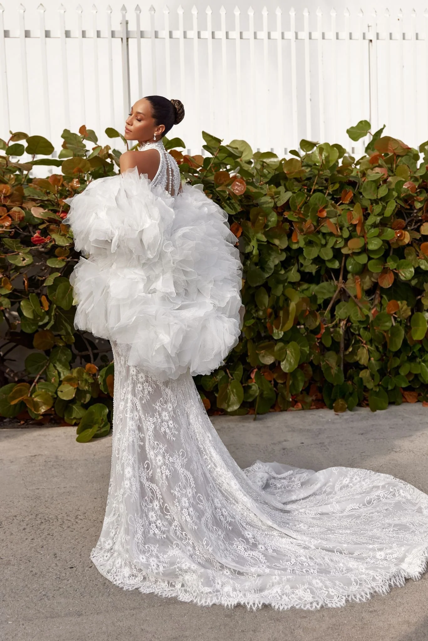 Oksana Mukha Marigold mermaid wedding dress with layered lace and mesh, high illusion back, decorative button trail, and 80cm train