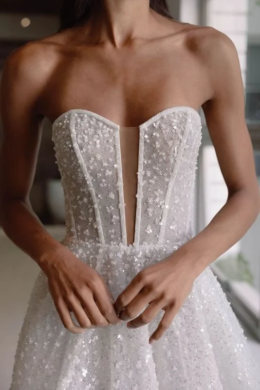 La Premiere Lise sparkle tulle wedding gown with beaded gradient effect, strapless sweetheart neckline, and detachable sleeves.