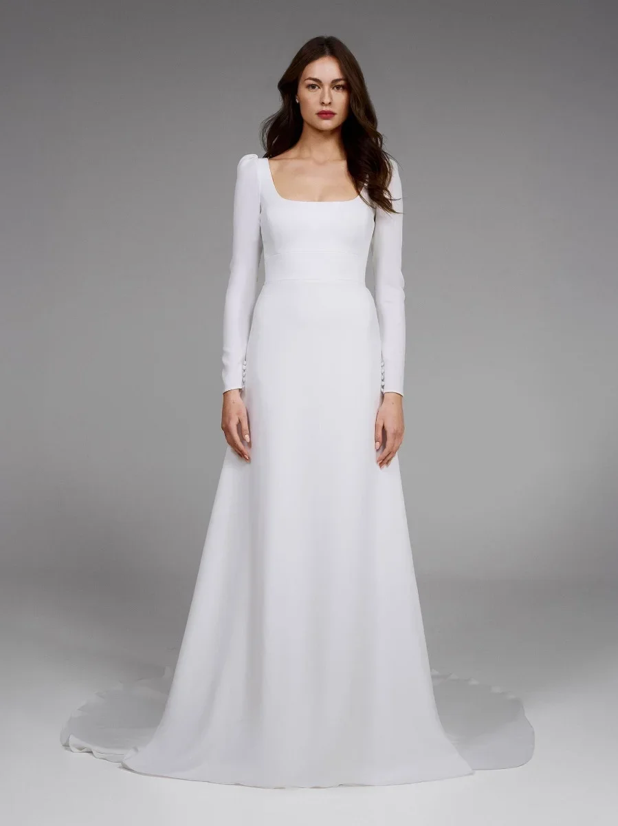 Pronovias Aspen crepe A-line wedding dress with a square neckline, long puff-shoulder sleeves, high waist, and seductive keyhole back.