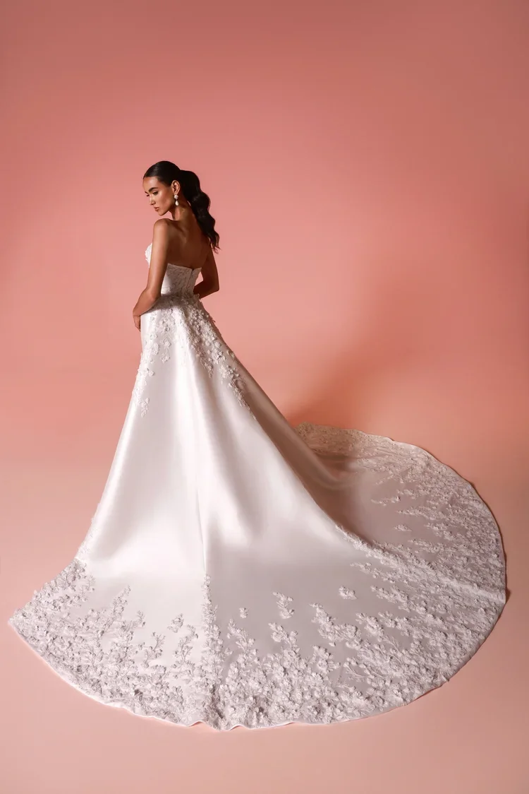 Dany Tabet Rivara strapless satin mermaid wedding dress with 3D floral appliqués and detachable overskirt at Bride To Be Couture Sacramento Back.webp