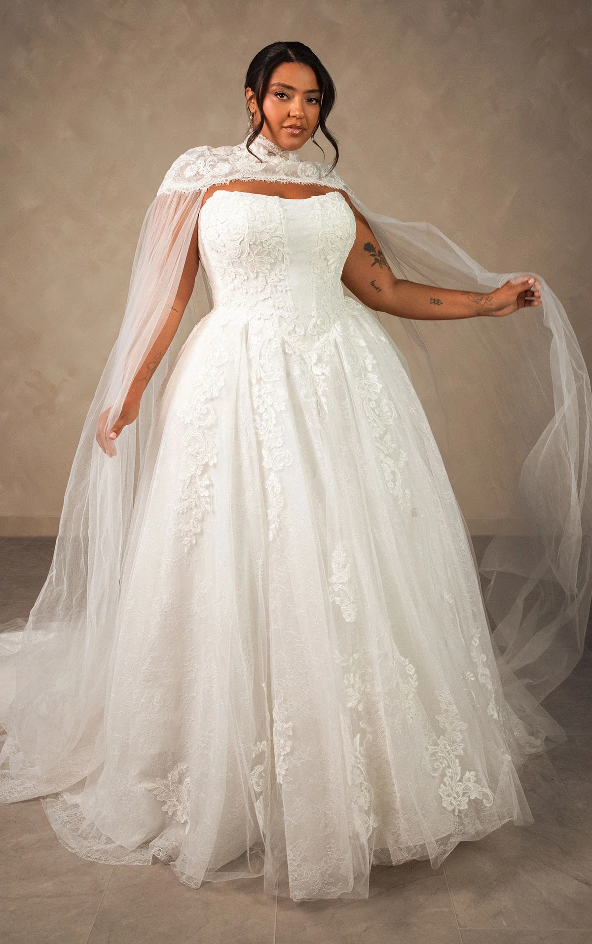 Essense of Australia D4553 enchanting strapless plus-size ballgown in lace and tulle with beaded corset bodice, detachable high-neck lace cape, and magnificent full-volume train