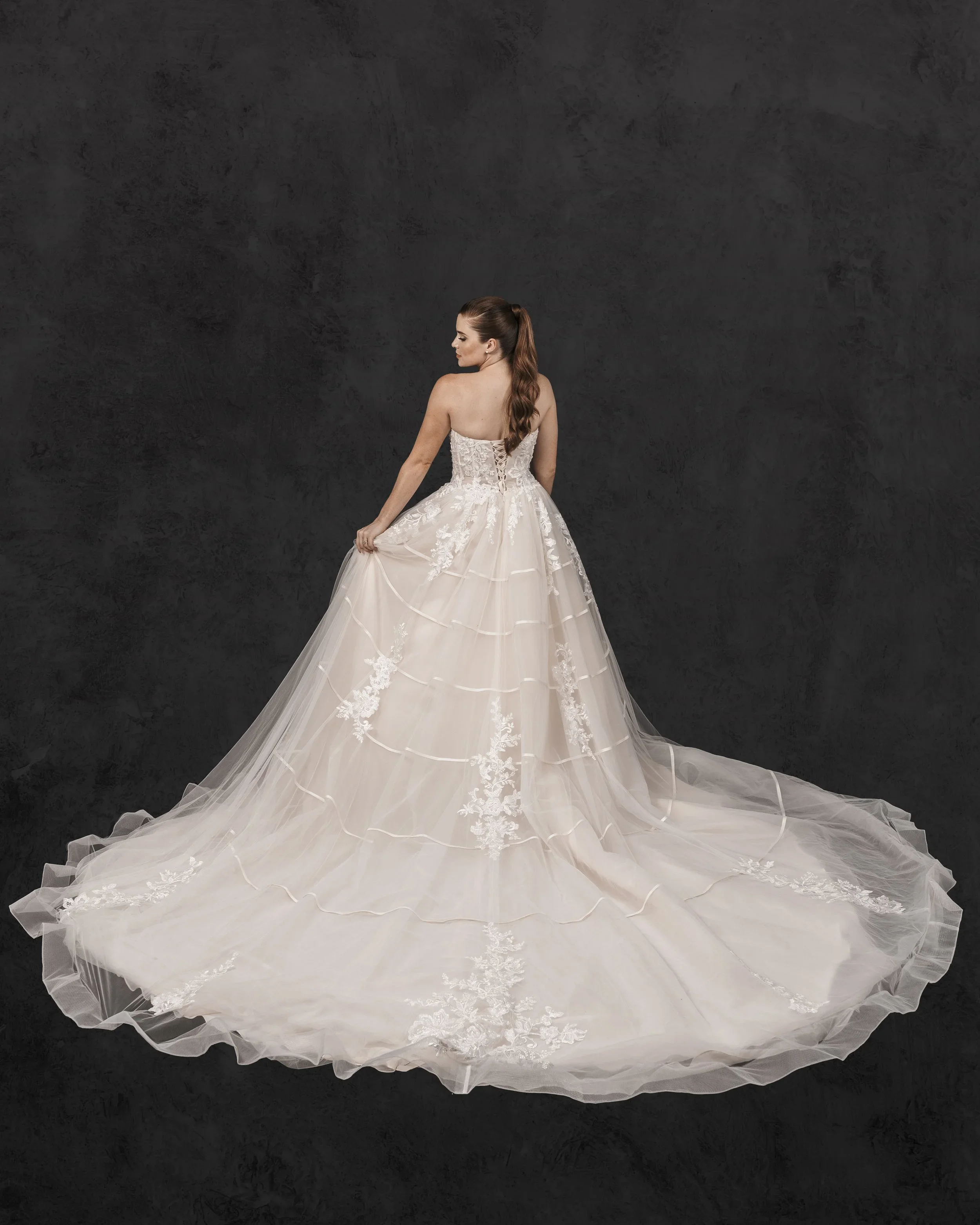 Elizabeth Lee Florence romantic beaded lace ballgown wedding dress with modern satin horizontal elements and corset bodice in ivory and champagne.