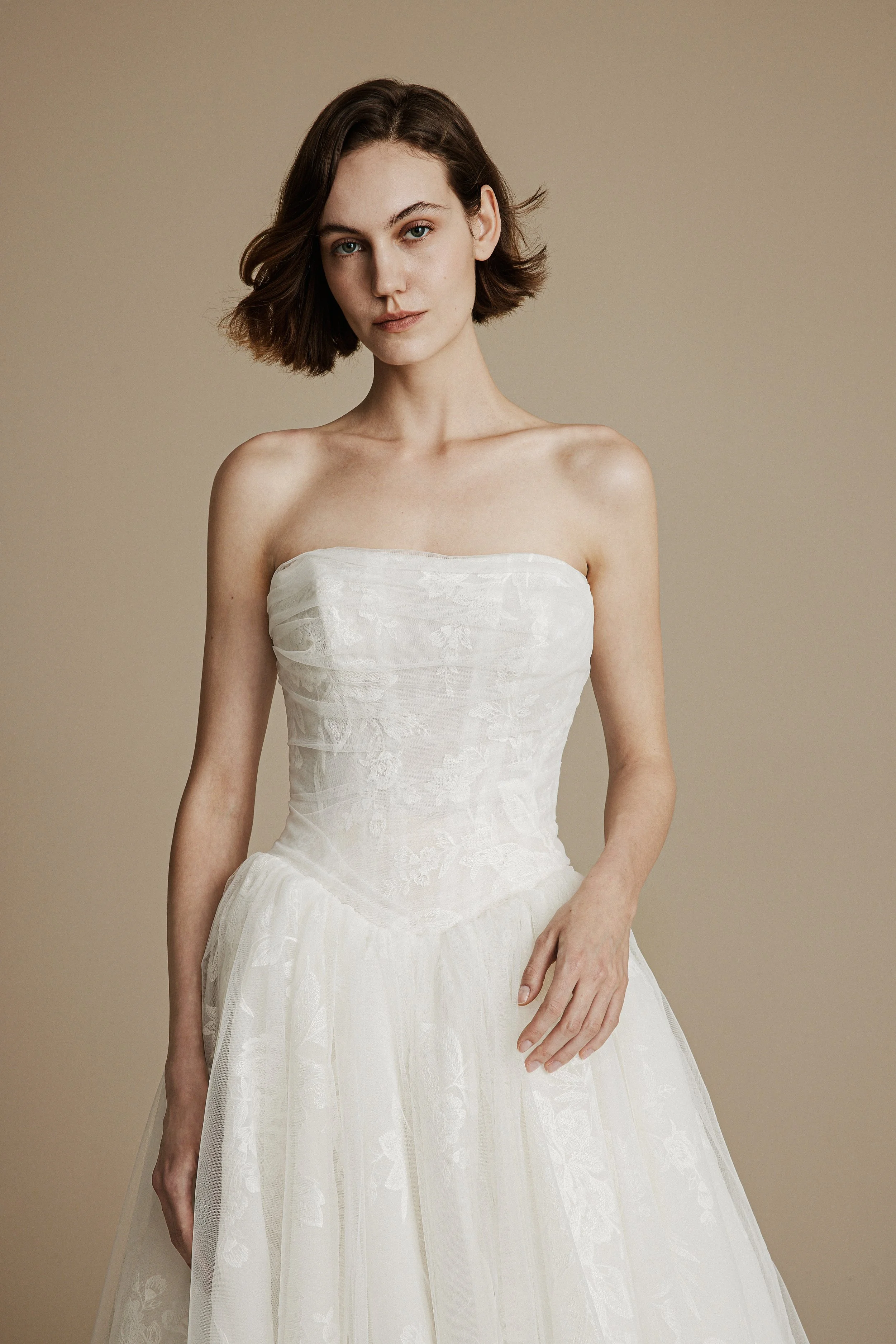 La Premiere Cleo lightweight organza ballgown wedding dress with strapless straight-across neckline, classical floral embroidery, and pleated voluminous skirt.