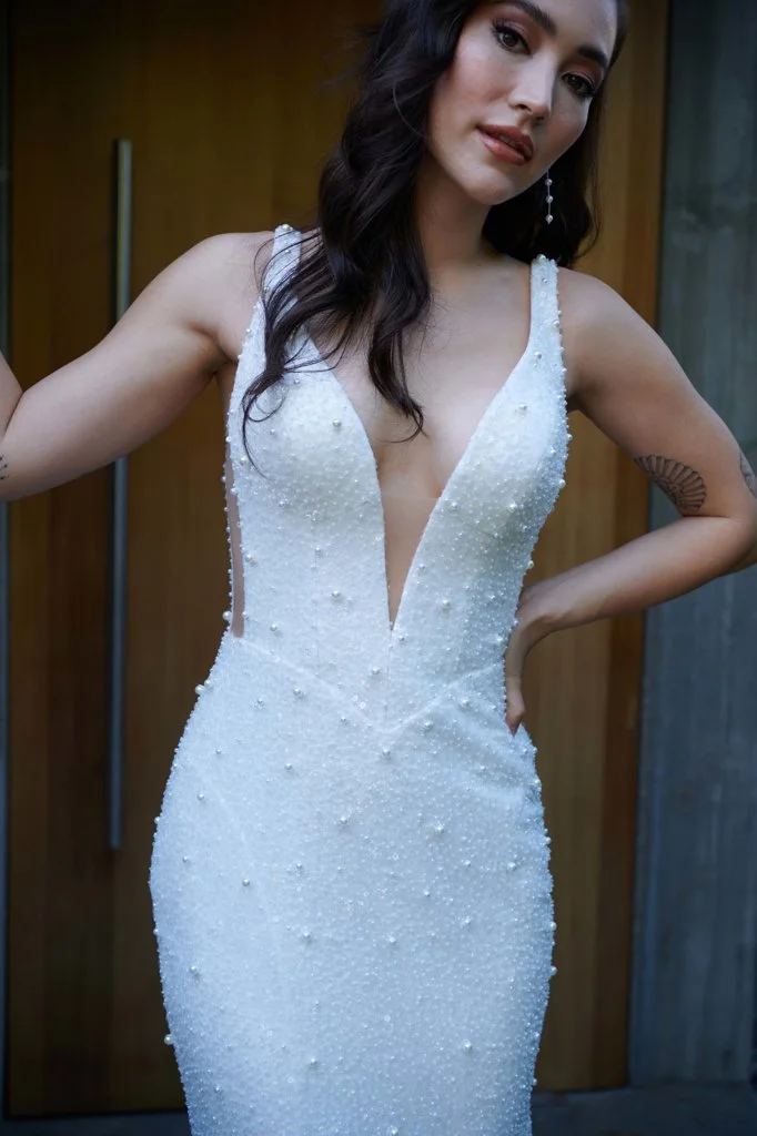 Serene Ame Lincoln fit-and-flare wedding dress with pearl beaded sequin fabric, plunging neckline, sheer sides, illusion back, and dramatic train godet.