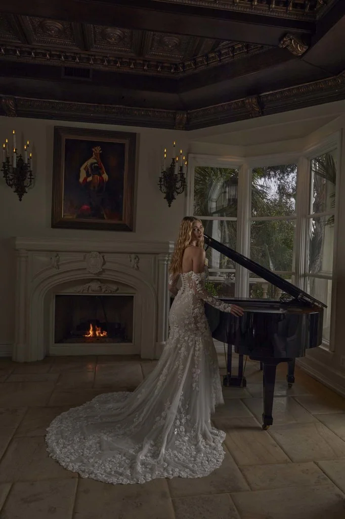 Serene Ame Raquel fit-and-flare wedding dress with 3D lace over soft tulle, sweetheart bustier, sheer sides, illusion train, and detachable off-shoulder sleeves.