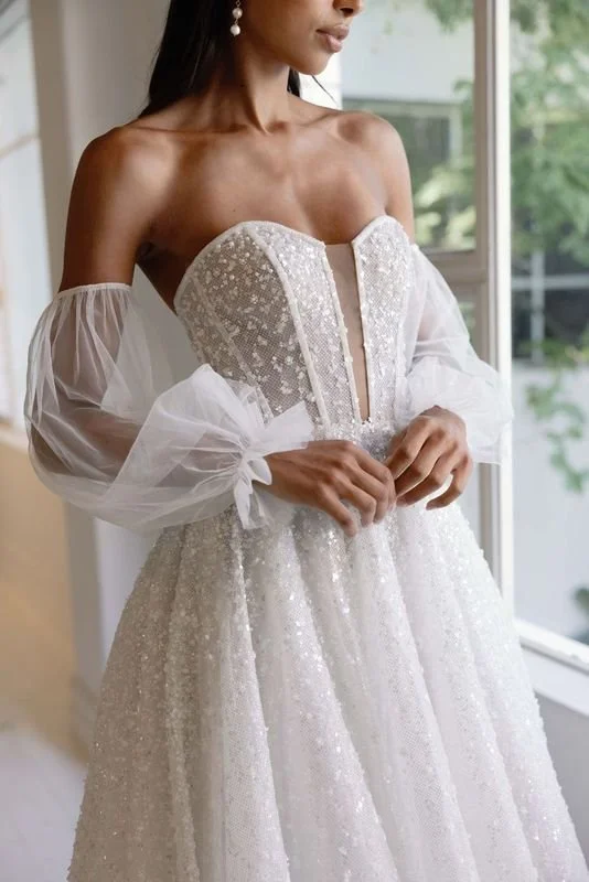 La Premiere Lise sparkle tulle wedding gown with beaded gradient effect, strapless sweetheart neckline, and detachable sleeves.