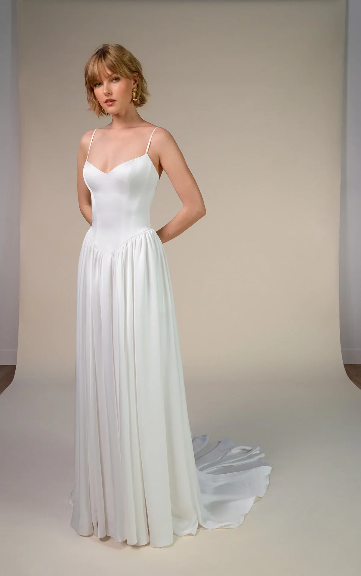 All Who Wander Keira satin A-line wedding dress with spaghetti straps, sweetheart neckline, basque waist, and detachable blouson sleeves, available at Bride To Be Couture in Sacramento.