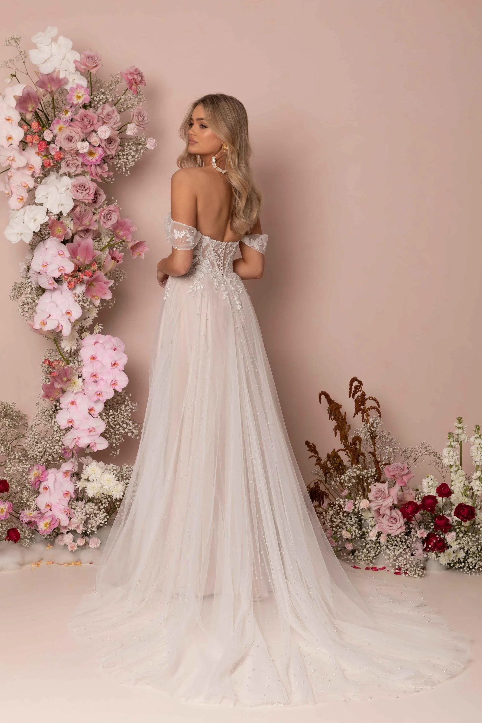 Madi Lane Kaiya ballgown wedding dress with a strapless sweetheart neckline, exposed boning, embroidered floral lace with pearls and sequins, and a 26-inch illusion train.