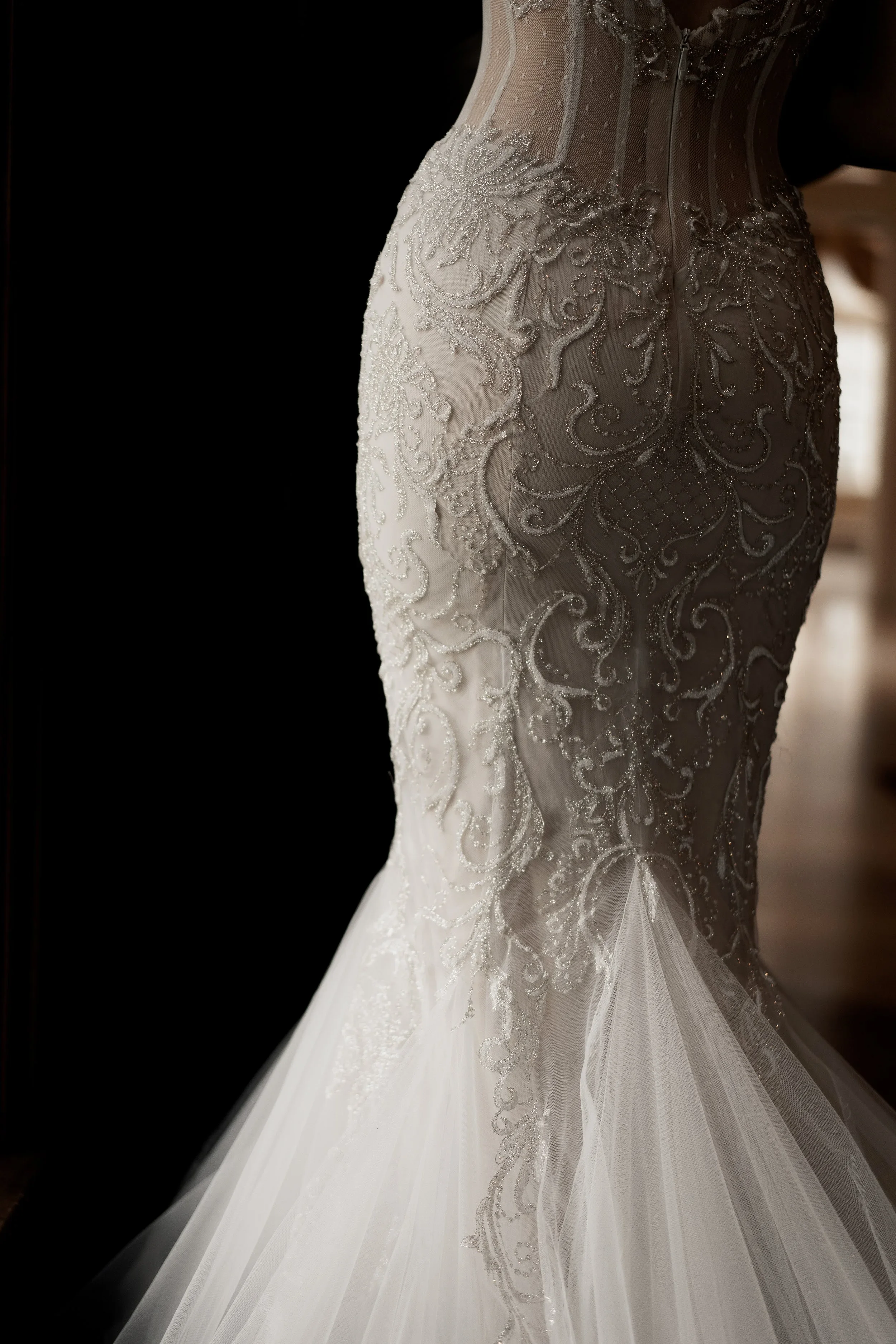 Elizabeth Lee Jordyn sparkling mermaid wedding dress with Israeli lace, plunging neckline, illusion back, and side cut-outs in ivory and nude.