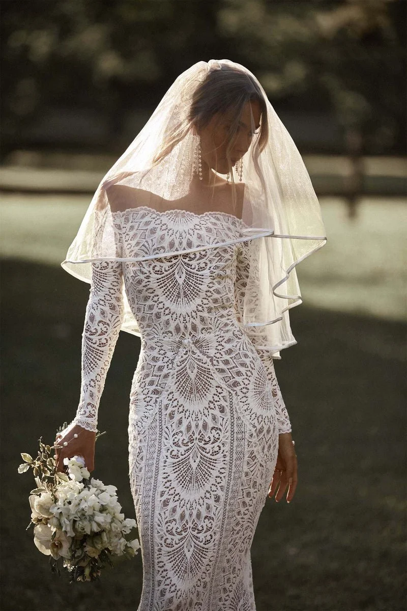 Nathalia by Grace Loves Lace stretch lace wedding dress with off-the-shoulder neckline, long sleeves, and scalloped train at Bride To Be Couture in Sacramento