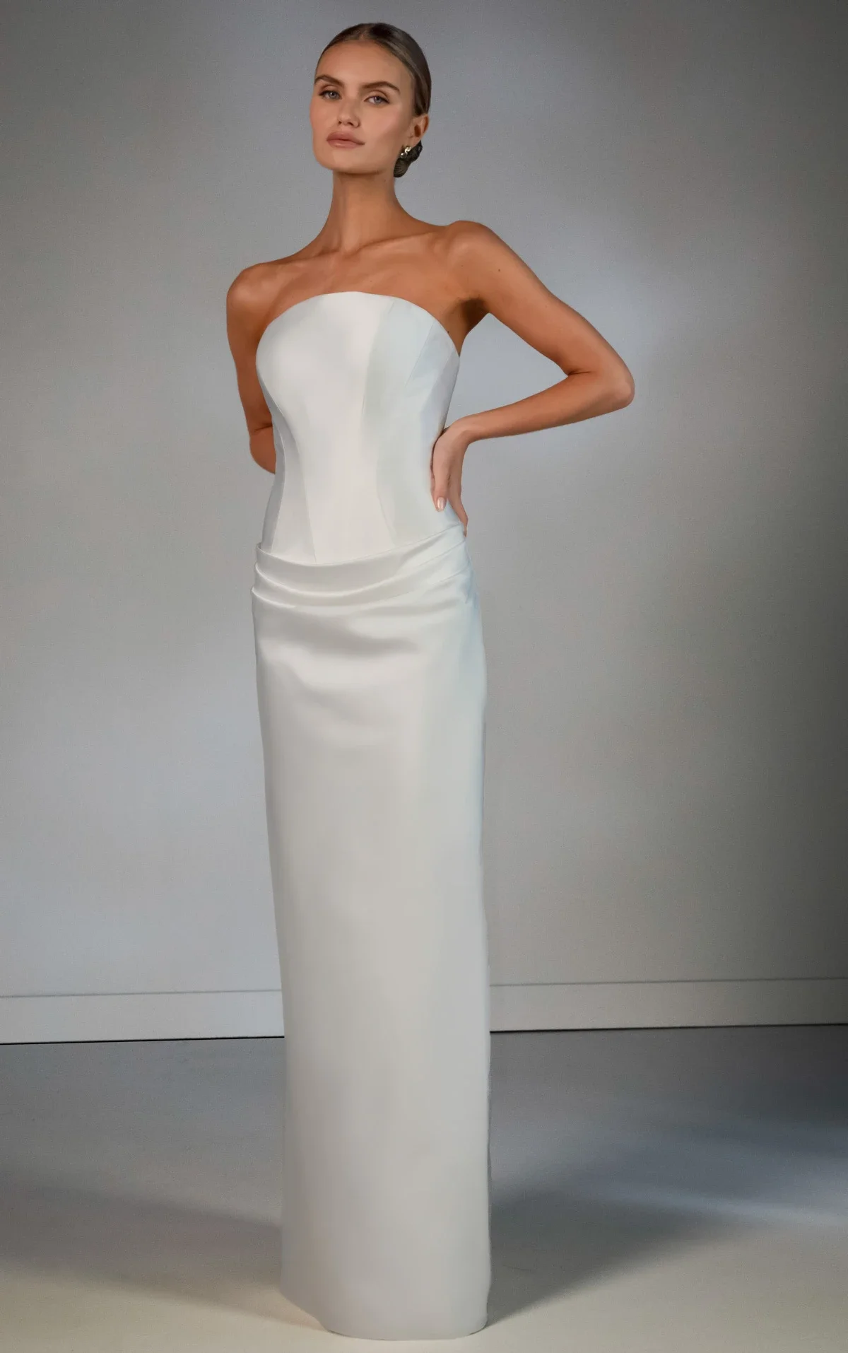 Martina Liana Luxe LE1460 strapless satin wedding dress with corset bodice, column silhouette, dramatic overskirt, and opera gloves at Bride To Be Couture Sacramento