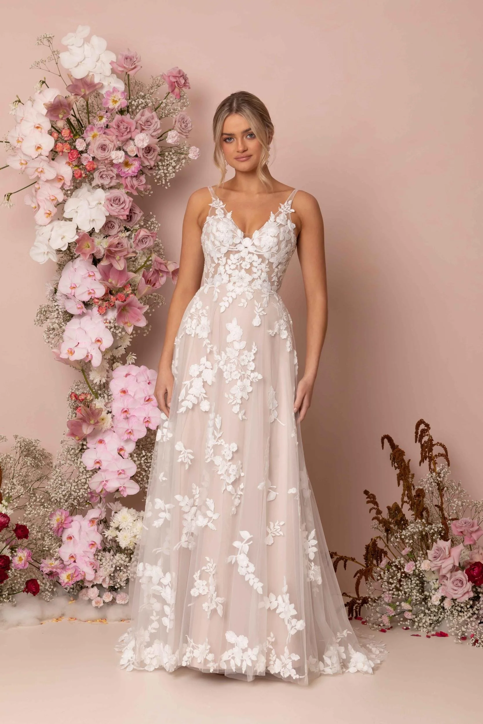 Madi Lane Katrine A-line wedding gown with a V-neck illusion lace bodice, detachable sheer puff sleeves, dispersed botanical sequin florals, and a 25-inch train.