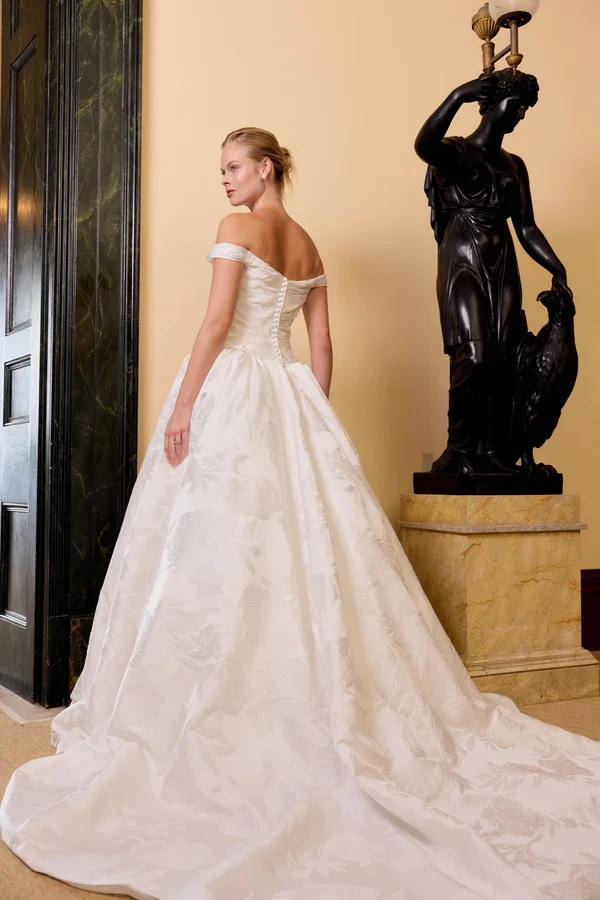 The Eloide gown, crafted from luxurious jacquard satin, features a chic two-piece design perfect for any wedding setting.