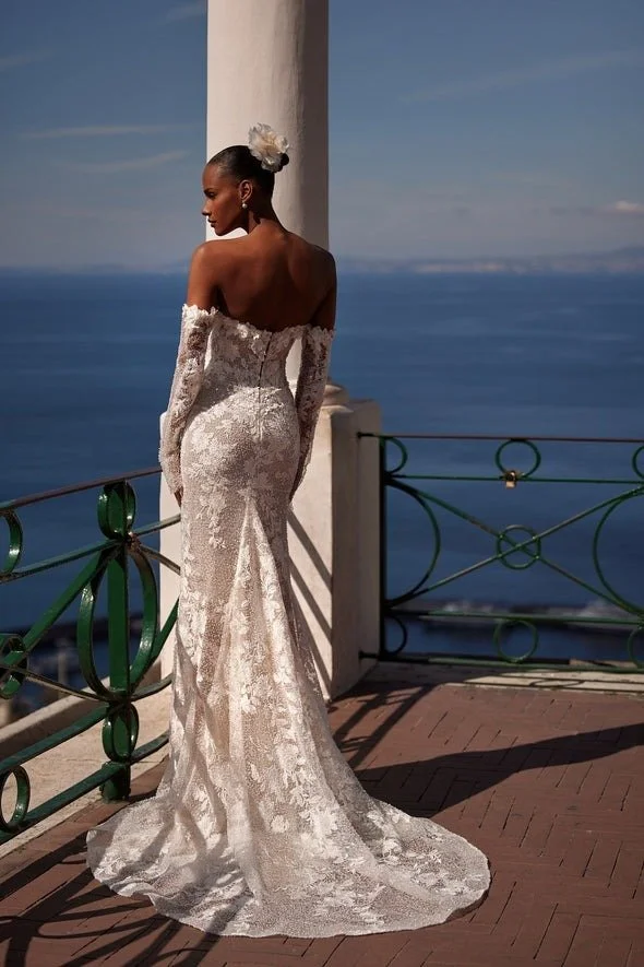 Julie Vino Gaia mermaid wedding gown with a strapless sweetheart plunge, optional off-the-shoulder long sleeves, dimensional 3D florals, and beaded lace.