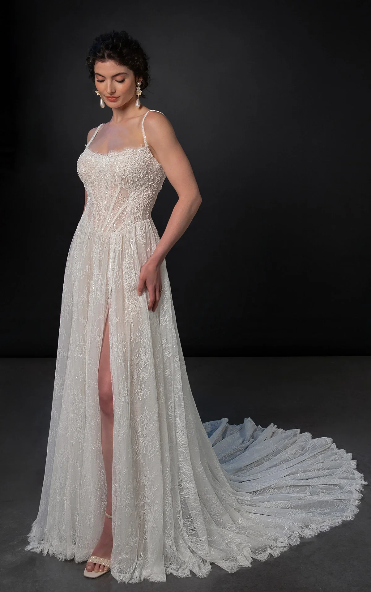 Martina Liana ML1945 beaded Chantilly lace A-line wedding dress with spaghetti straps, sweetheart neckline, basque waist, and high-leg slit, available at Bride To Be Couture in Sacramento