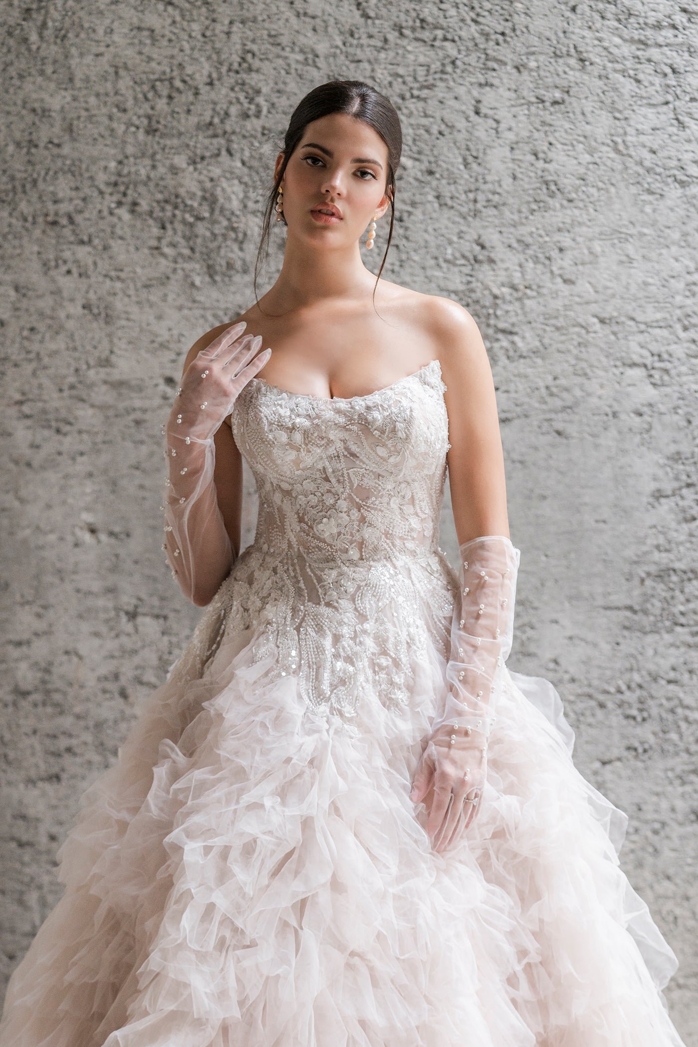 Allure Couture C691 close-up of strapless bodice with 3D floral and feather appliqués on blush ballgown - Front Detail