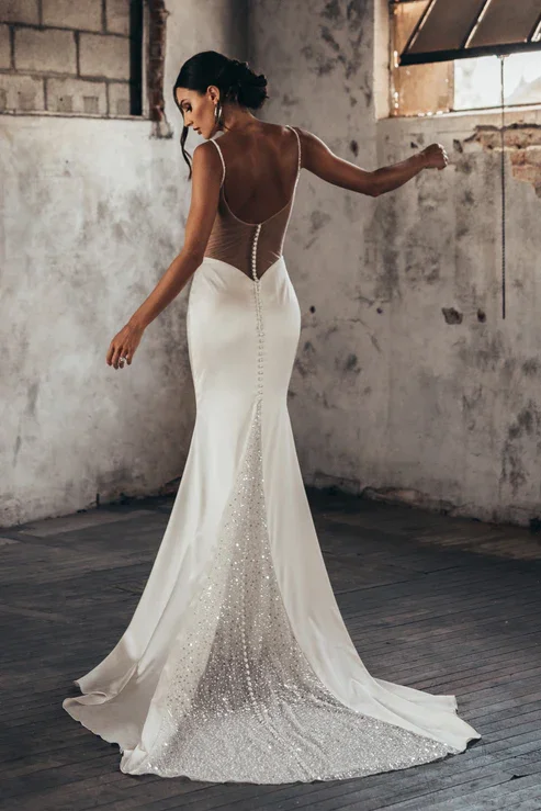 Serene Ame Ruby satin sheath wedding dress with cowl neckline, exposed bustier, beaded straps, and illusion back with beaded train.