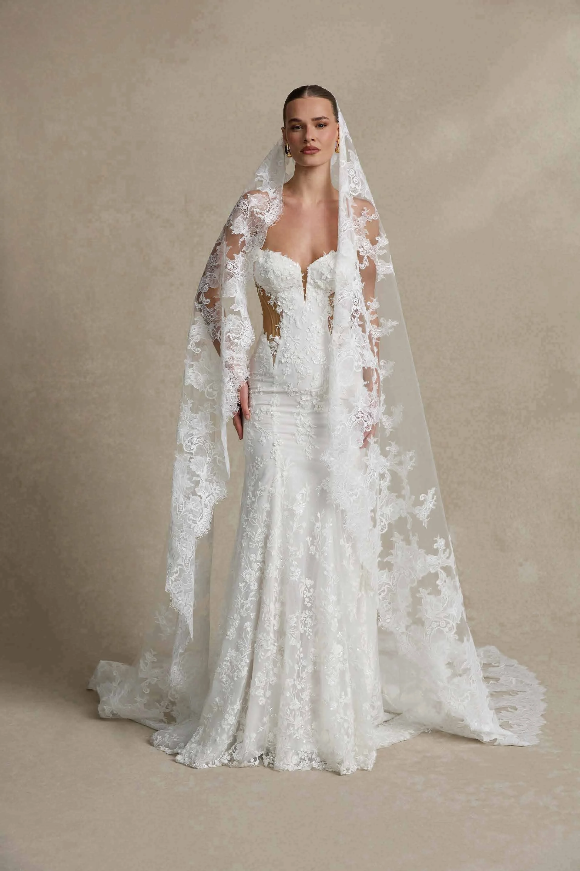 La Premiere Brixley beaded lace mermaid wedding dress with plunging sweetheart neckline, sheer center panel, and handcrafted 3D floral appliqués.