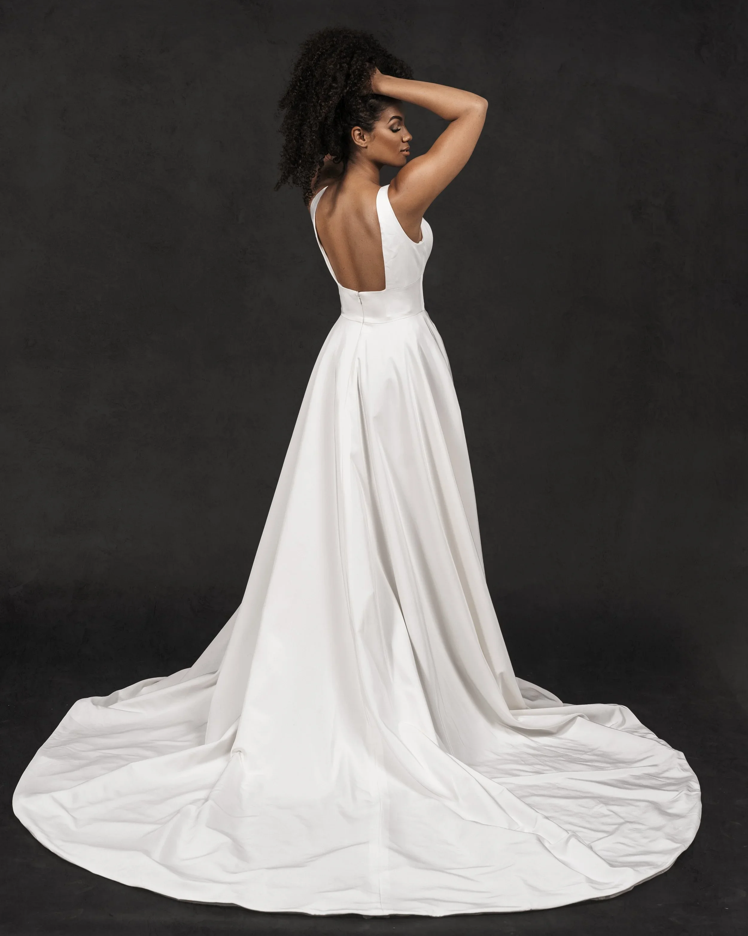 Elizabeth Lee Belle stretch crepe A-line wedding dress with scoop neckline, low square back, and hidden pleated slit.