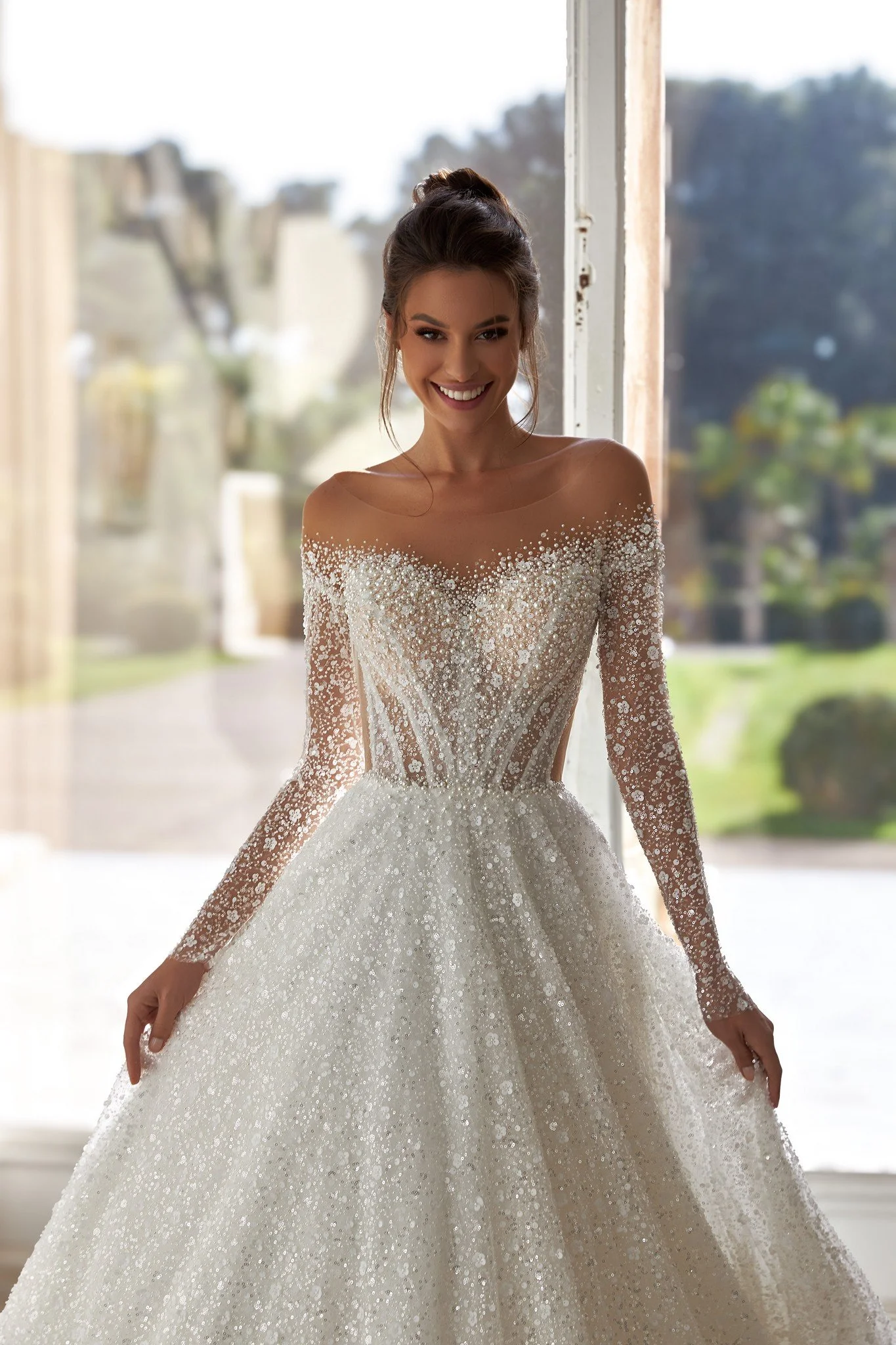 Oksana Mukha Sophie A-line wedding dress with long sleeves, pearl-bead-crystal embroidered bodice, closed button back, and refined sparkle