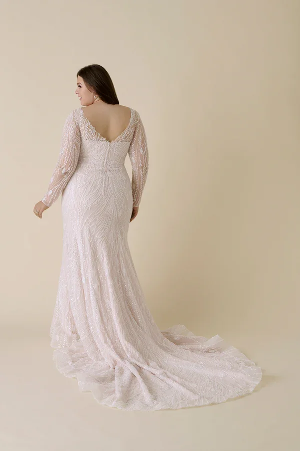 Allure Bridals W549 plus size beaded fit and flare wedding gown with plunging V-neckline, sheer long sleeves, and intricate pearl and sequin embellishments over tulle.