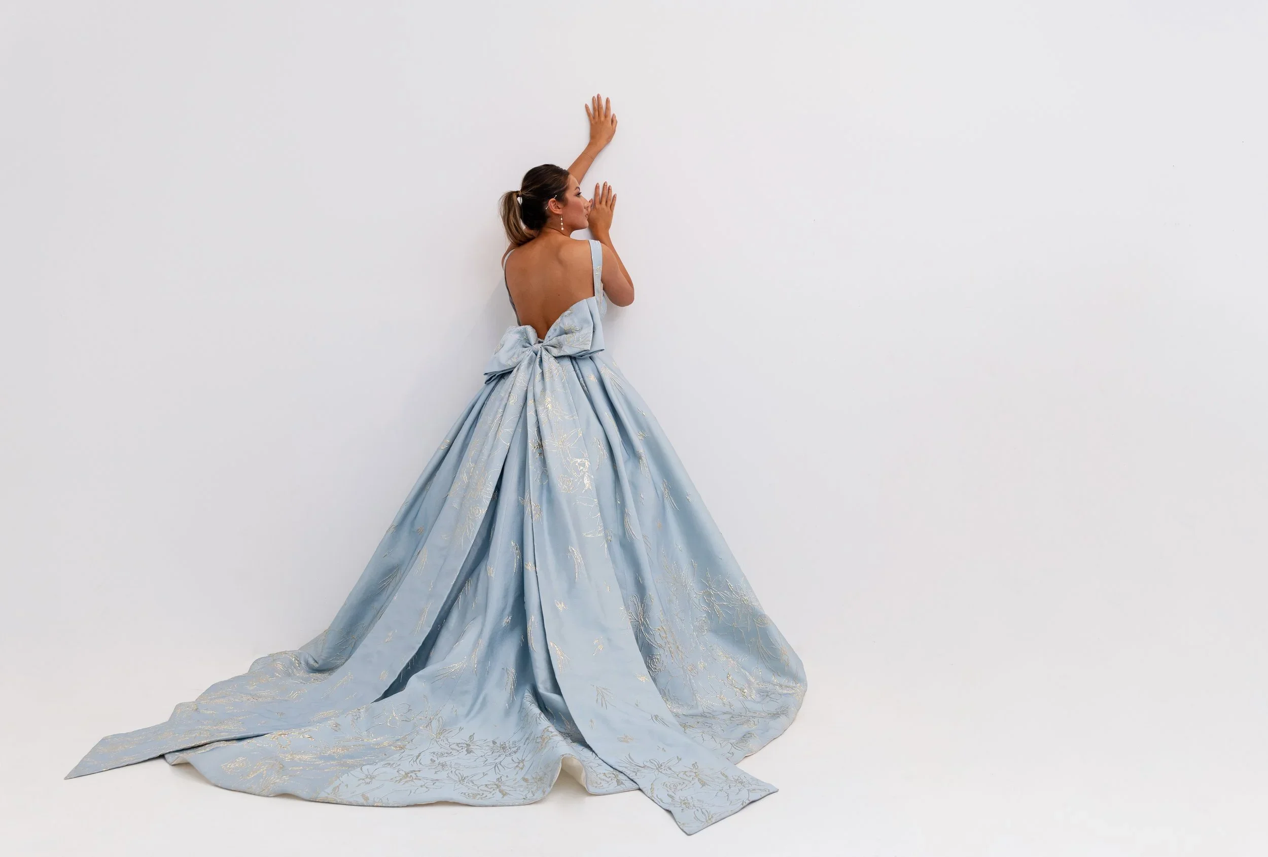 Elizabeth Lee Elizabeth blue brocade wedding dress with intricate gold embroidery, strapless sweetheart neckline, low back, and detachable bow.