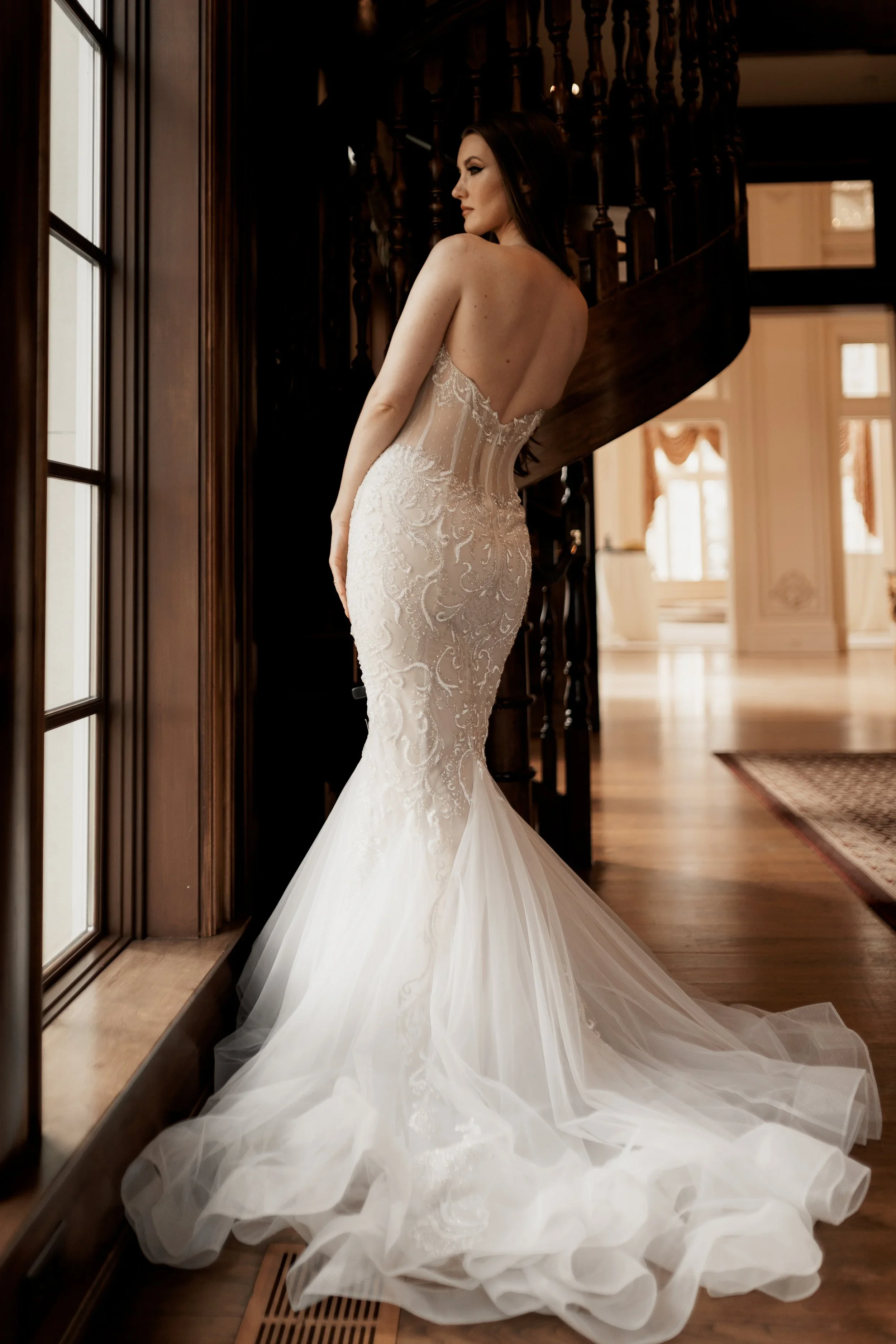 Elizabeth Lee Jordyn sparkling mermaid wedding dress with Israeli lace, plunging neckline, illusion back, and side cut-outs in ivory and nude.