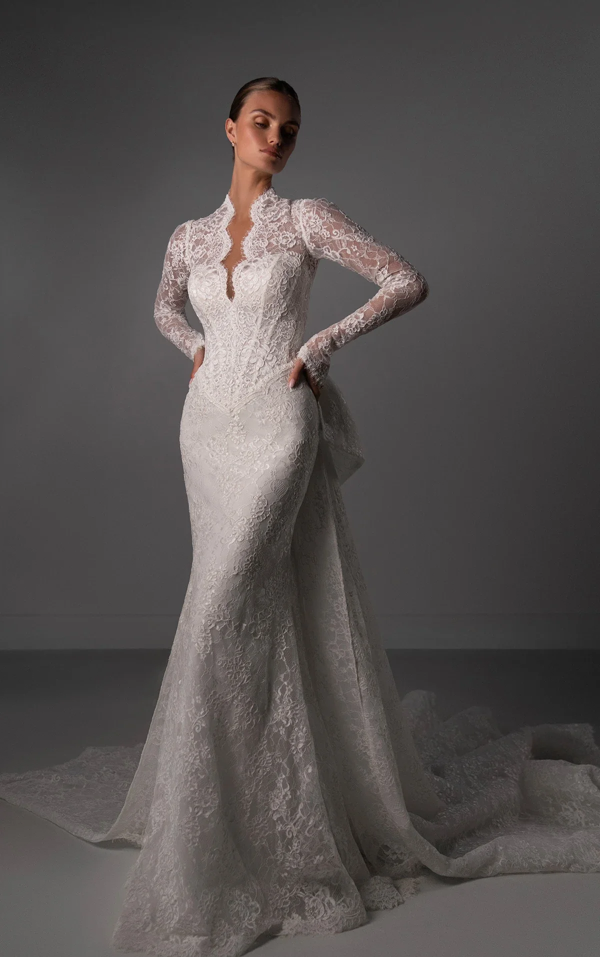 Martina Liana Luxe LE1450 Chantilly lace sheath wedding dress with scallop-edge plunge neckline, basque waist, and detachable train, available at Bride To Be Couture in Sacramento.
