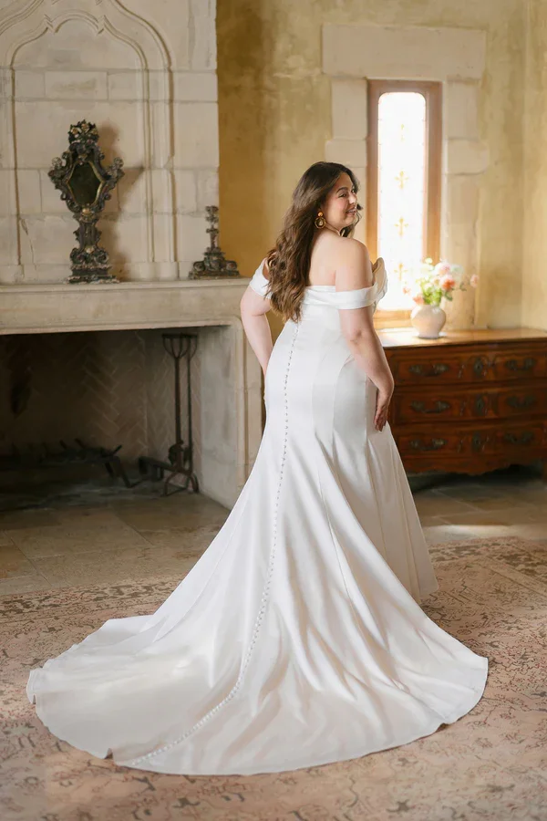 plus size fit and flare wedding gown with sweetheart neckline, off-the-shoulder draped straps, and ruched bodice