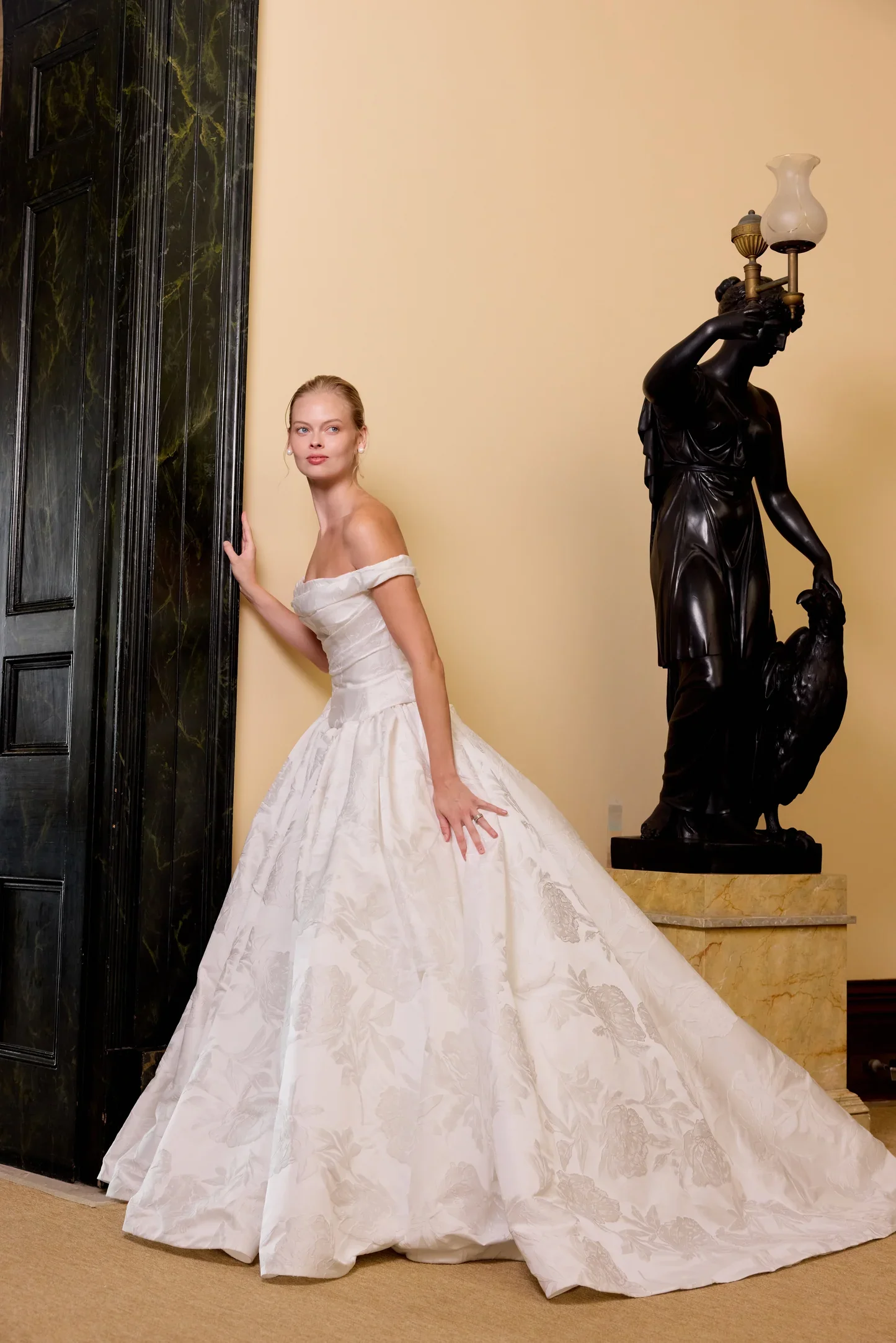 The Eloide gown, crafted from luxurious jacquard satin, features a chic two-piece design perfect for any wedding setting.