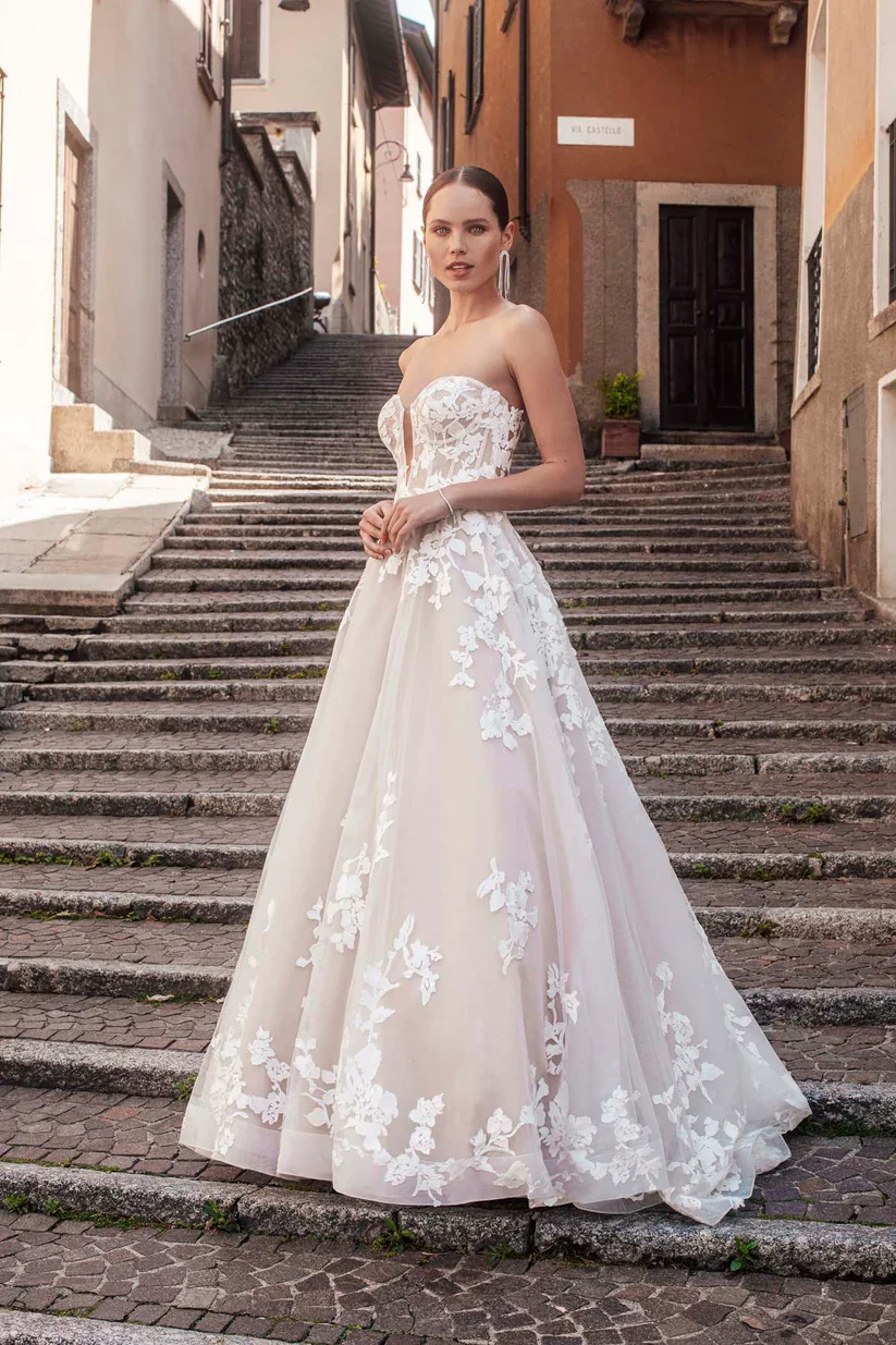 Madison James Harper lace A-line wedding dress with detachable puffed tulle sleeves and romantic lace detailing throughout.