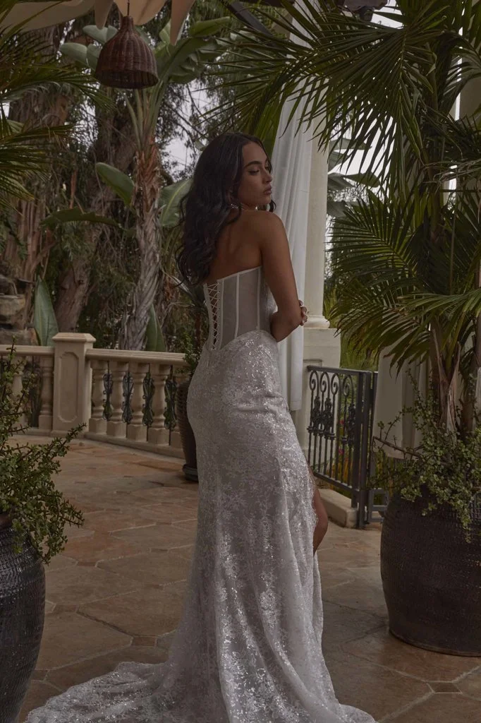 Serene Ame Violette strapless sequin Chantilly lace sheath wedding dress with eyelash trim, ruched skirt, corset back, and daring side slit.