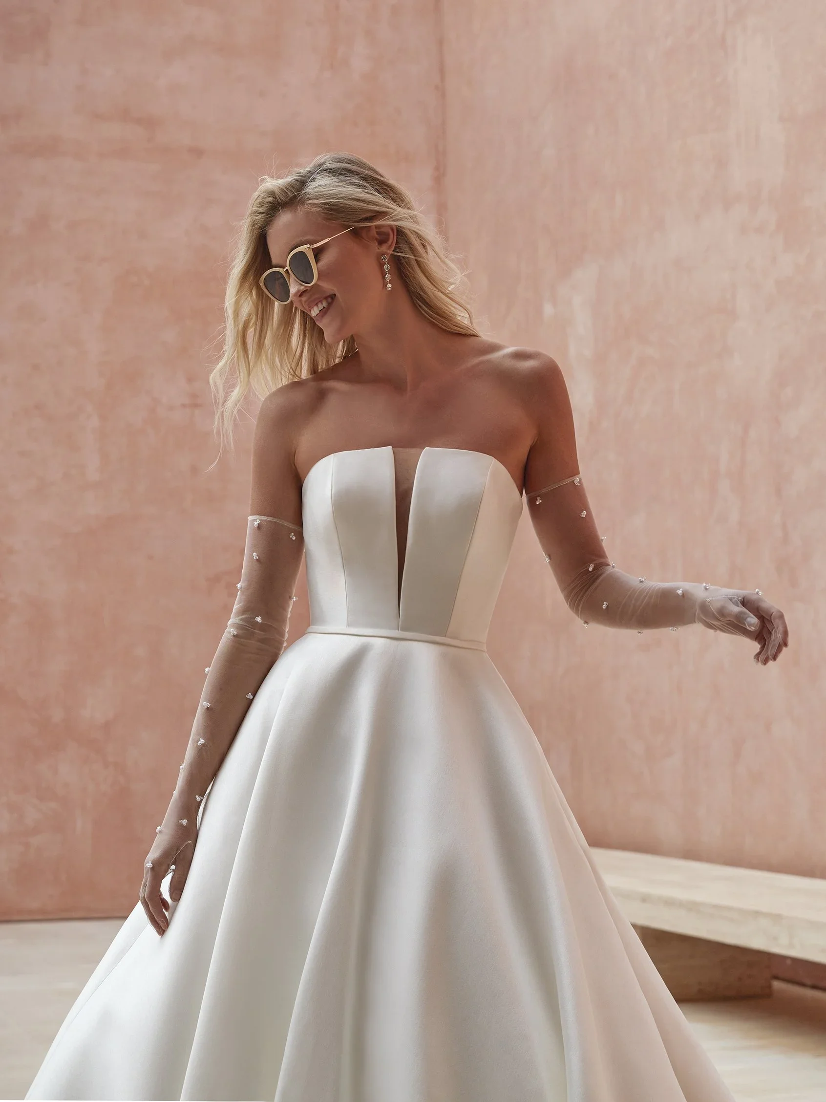 Pronovias Ozen A-line wedding dress in silken Mikado with a deep illusion V-neckline, fitted bodice, and softly draped skirt.